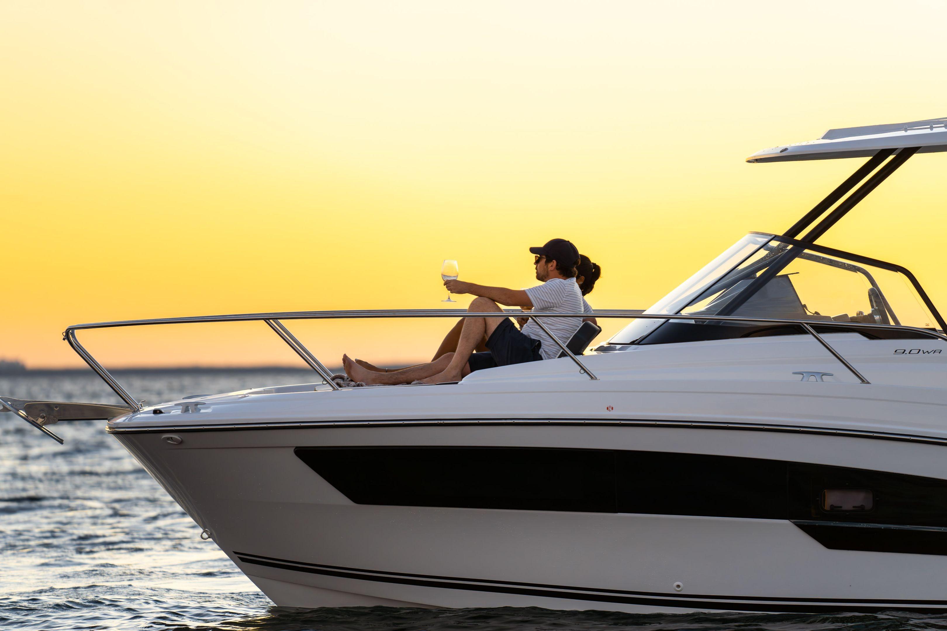 2026 Jeanneau Leader 9.0 WA boat at sunset with person relaxing onboard.