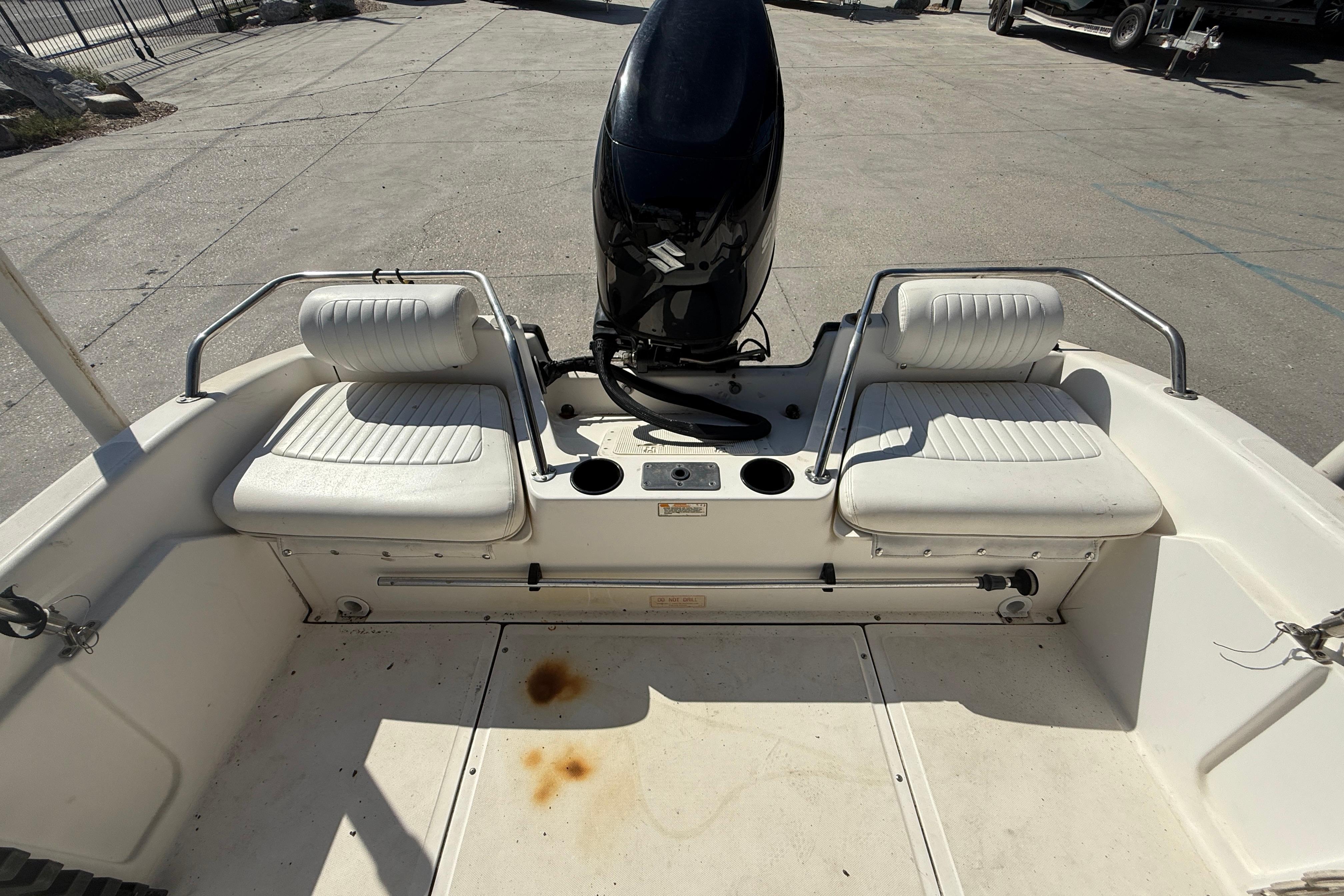 2002 Boston Whaler Ventura 160 boat interior with seating and motor.