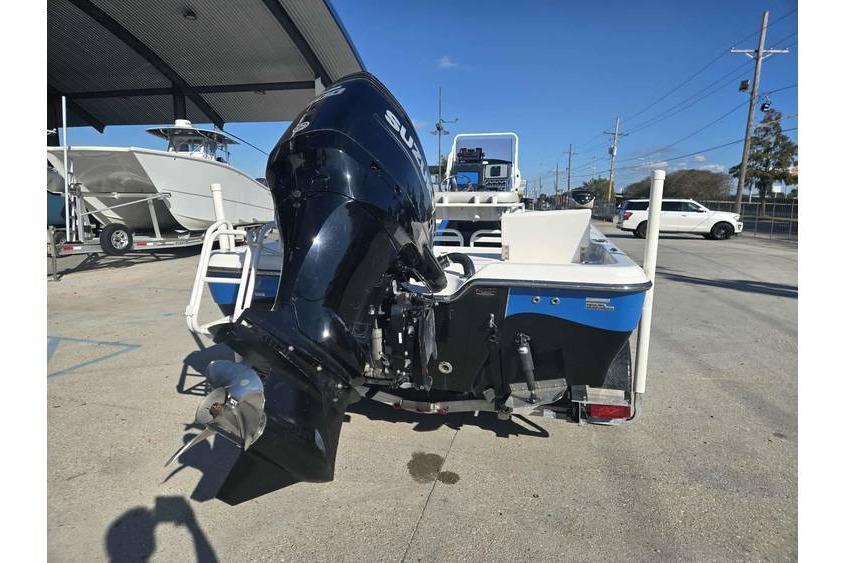 2020 Blue Wave 2400 PureBay boat with powerful outboard motor in a marina setting.