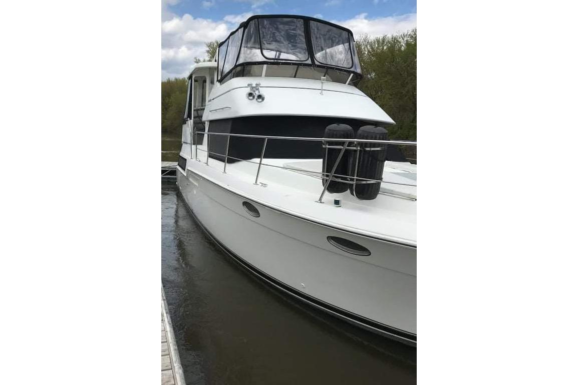 1998 Carver 355 Aft Cabin Motor Yacht docked on a calm waterway.