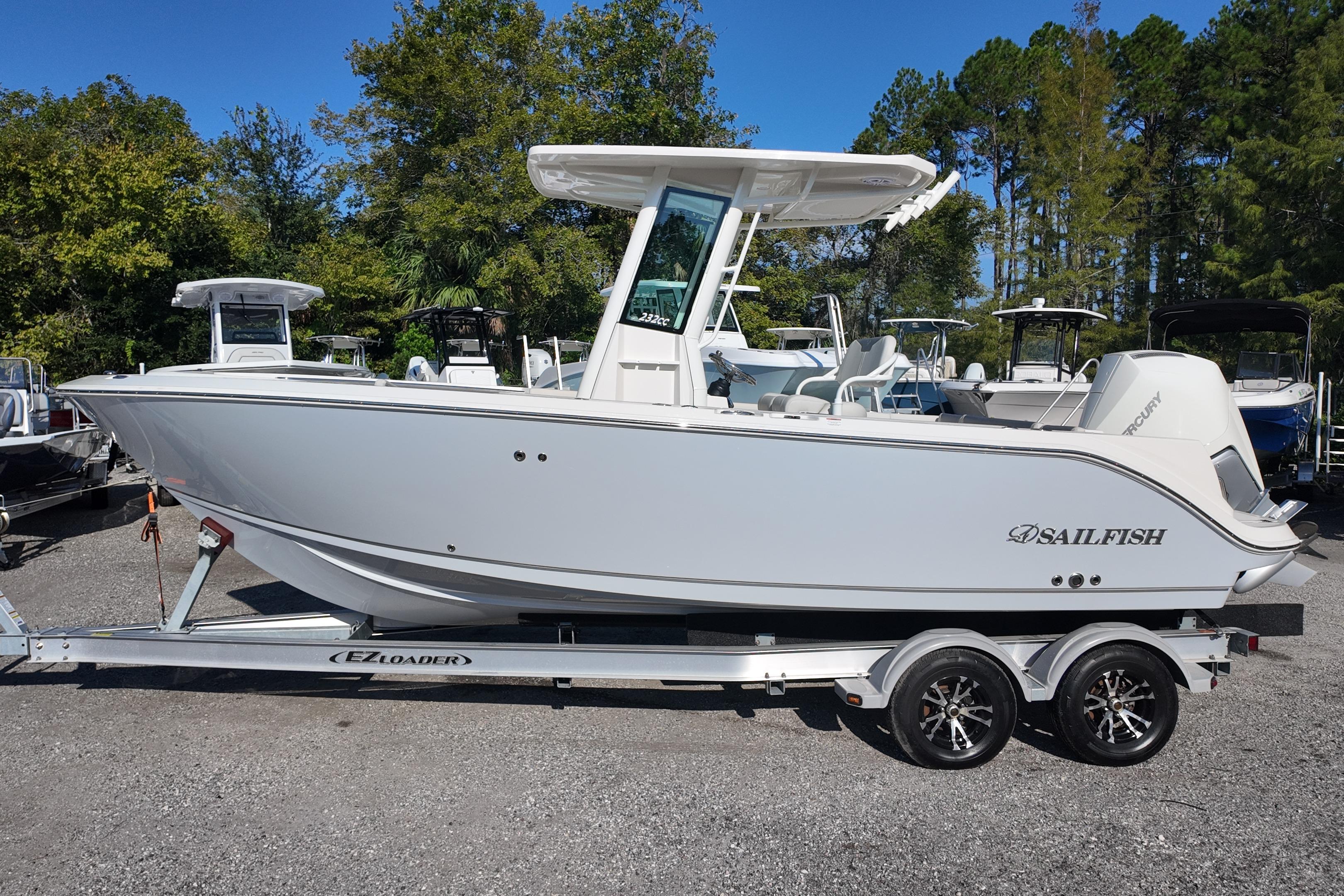2026 Sailfish 232 CC boat on trailer, parked outdoors with trees in background.