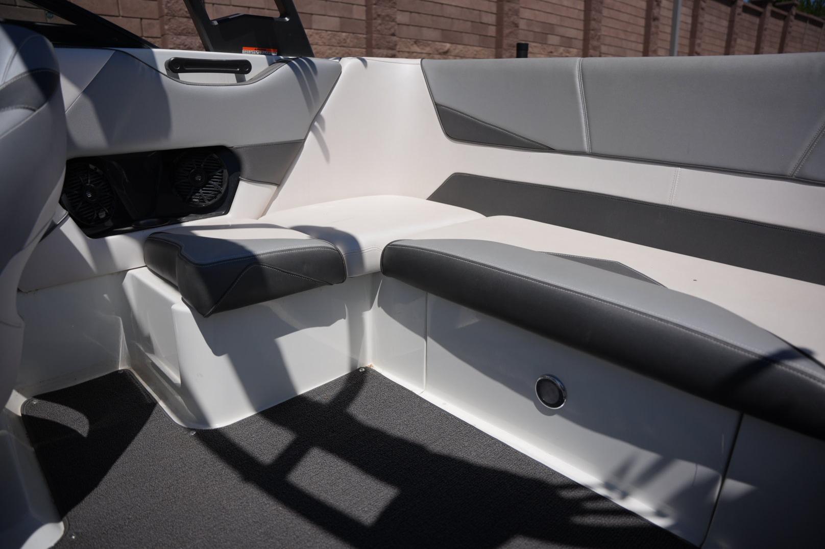 Interior of a 2016 Supreme S211 boat with gray and white seating.