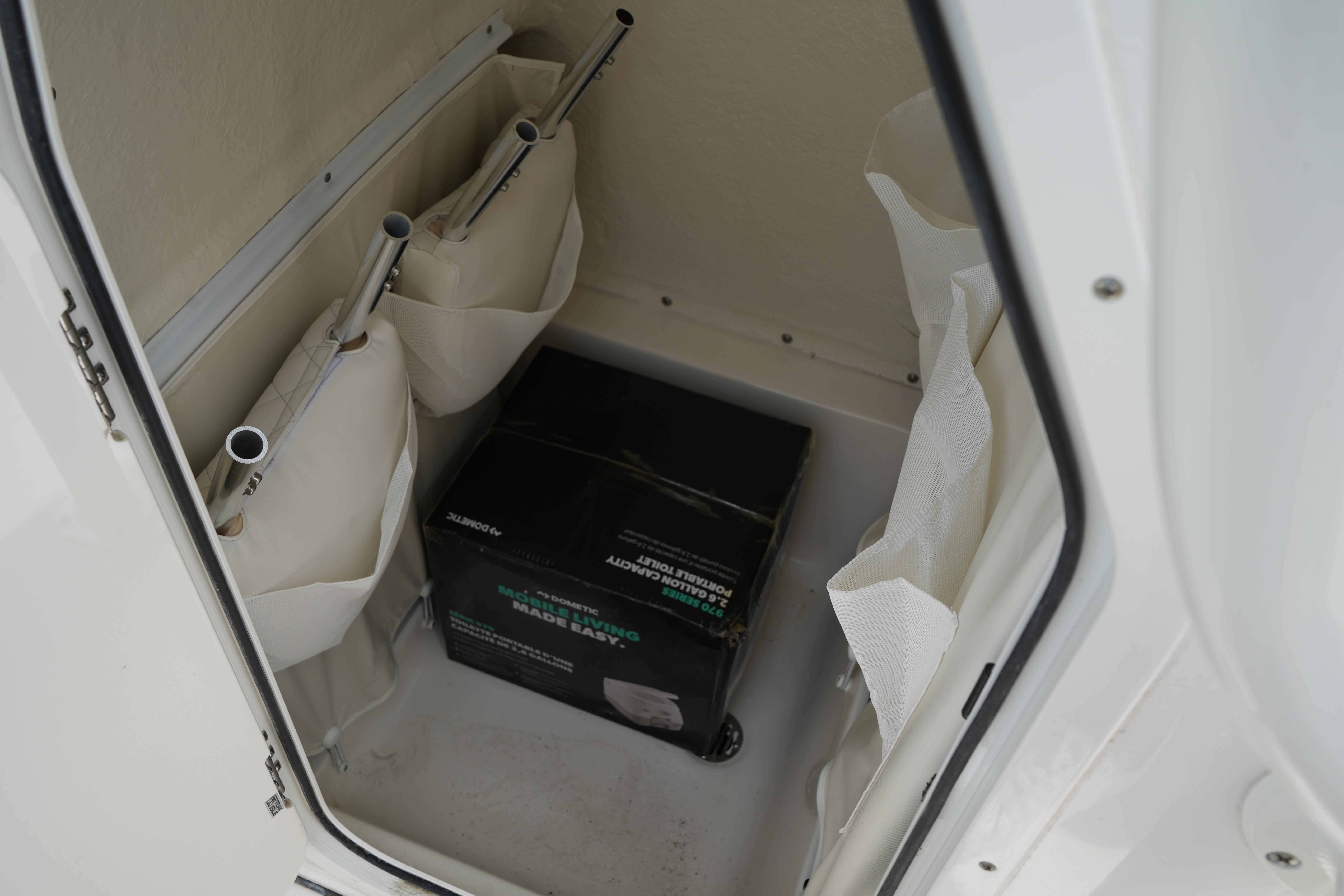 Storage compartment in a 2026 Key West 219 FS boat with organized equipment.