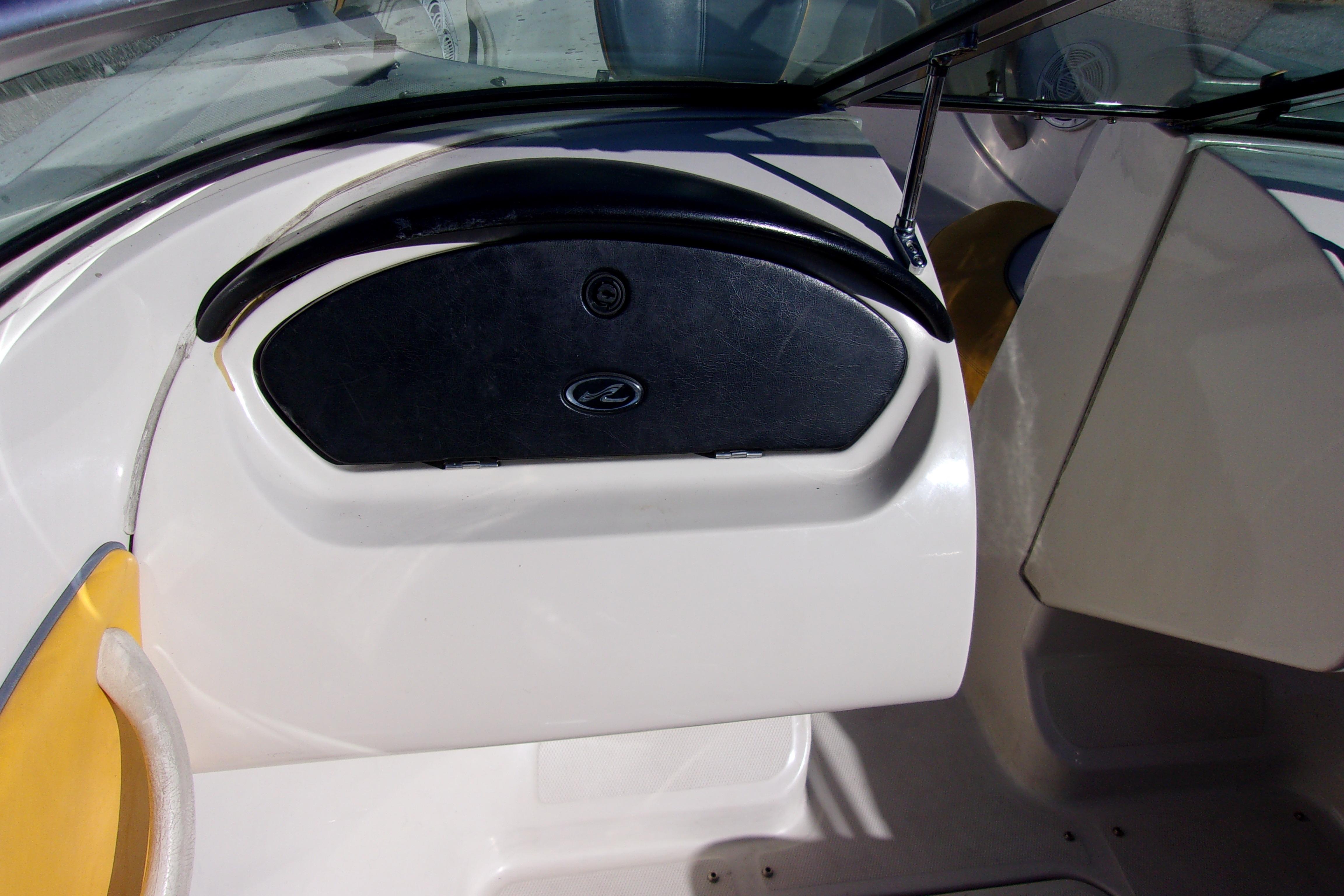 2007 Sea Ray 185 Sport boat interior with black dashboard and yellow seating.