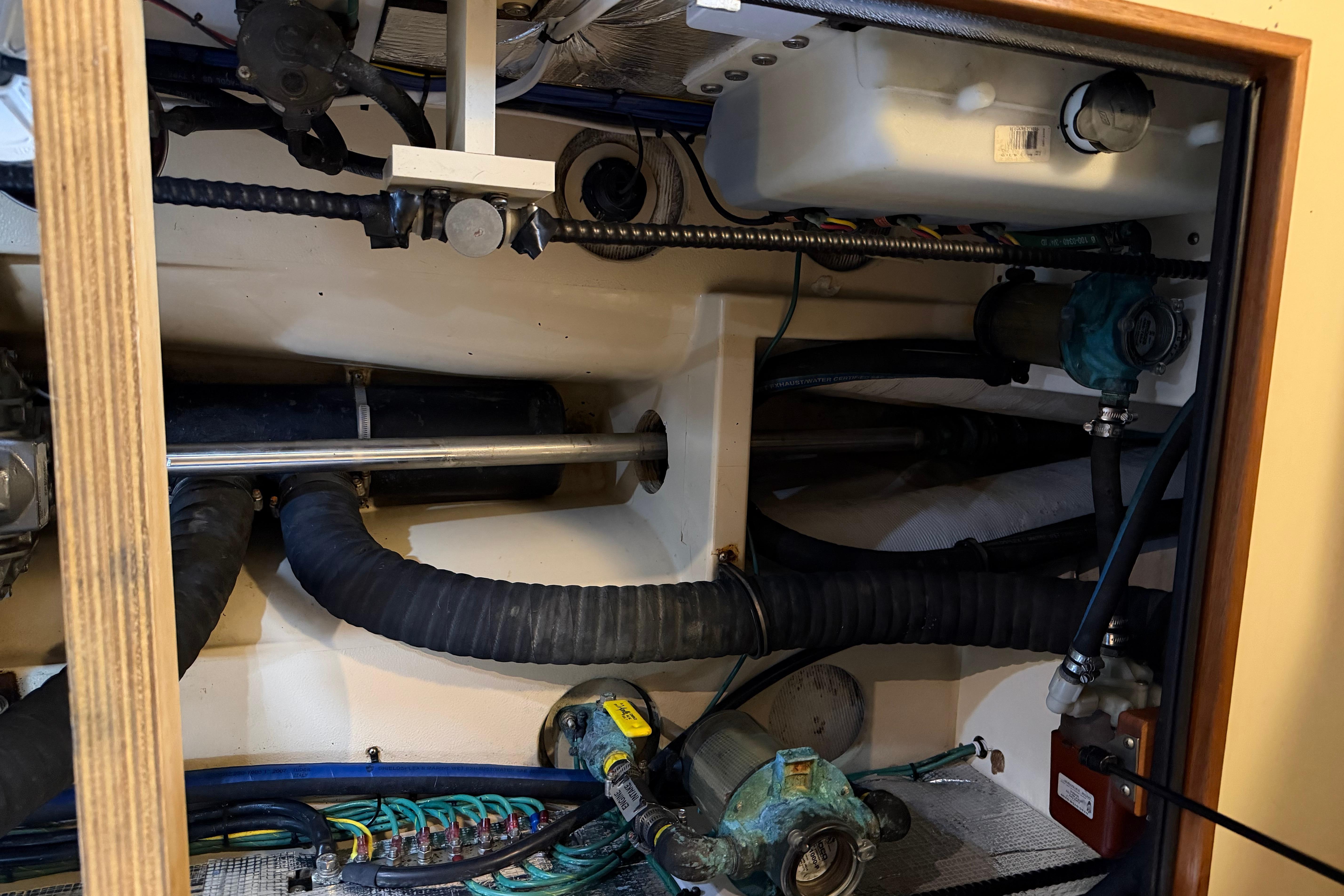 Engine compartment of a 2008 Island Packet SP Cruiser, showcasing mechanical components and hoses.