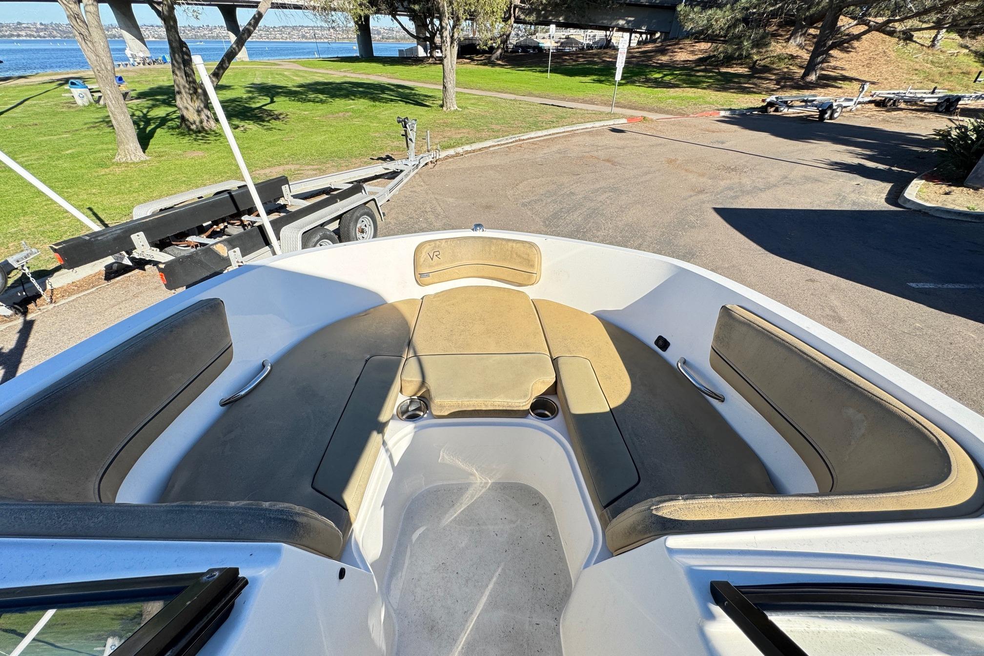 2022 Bayliner VR6 Bowrider OB interior with spacious seating and scenic waterfront view.