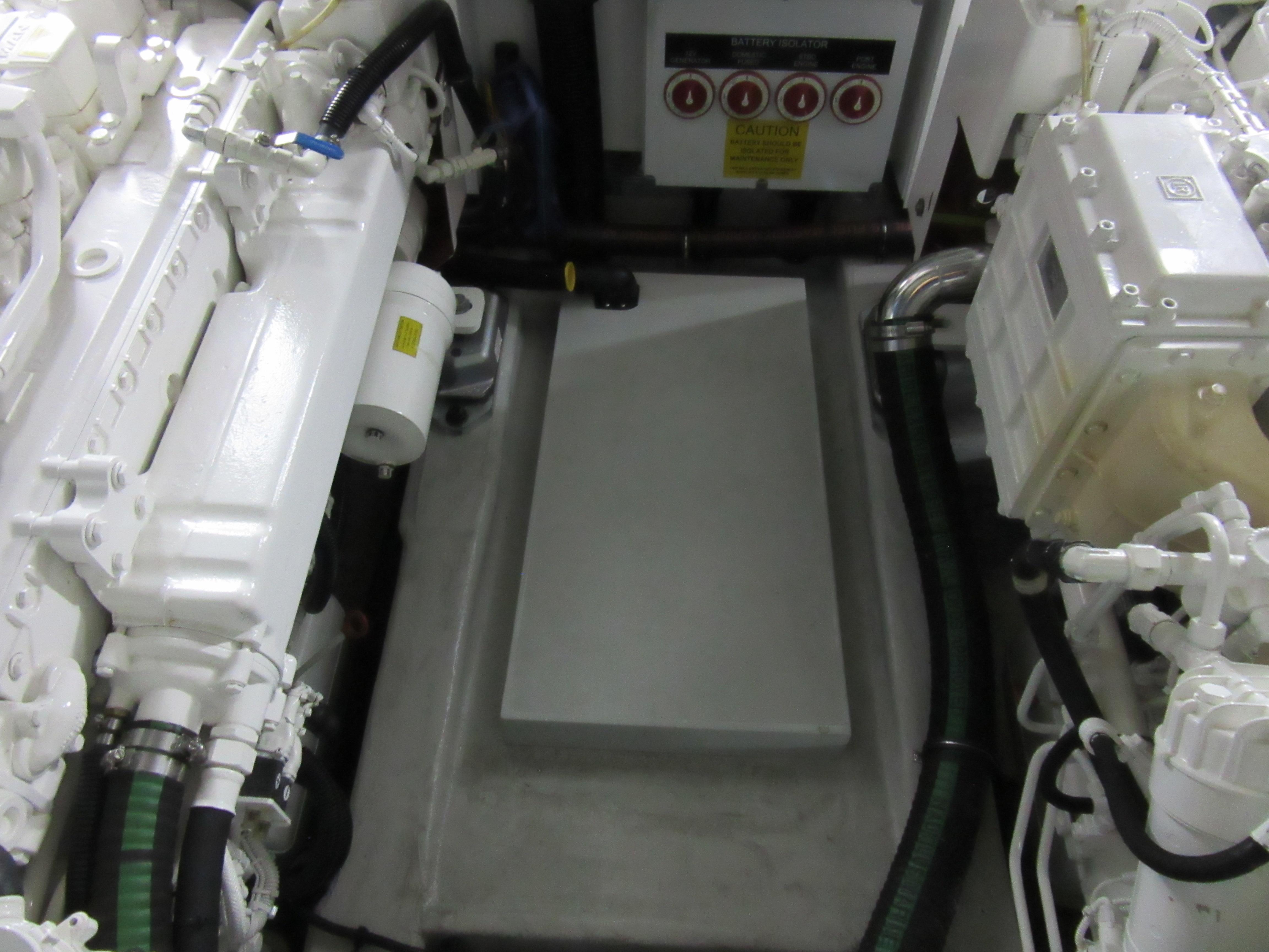 Engine room of a 2014 Sunseeker Manhattan 53 yacht, showcasing mechanical components.