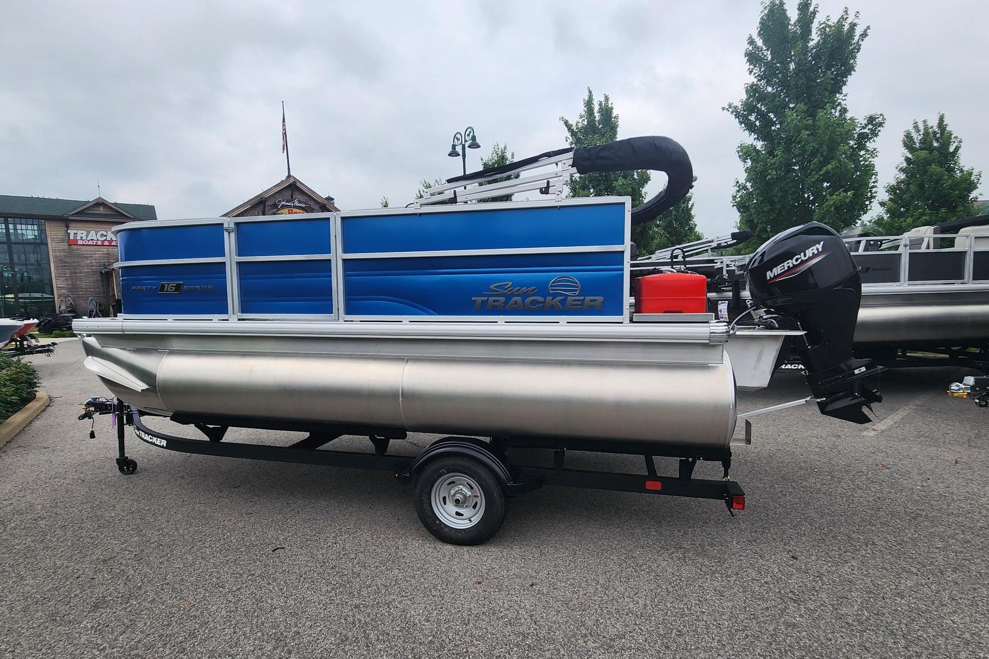 2026 Sun Tracker Party Barge 16 DLX pontoon boat on trailer, outdoor display.