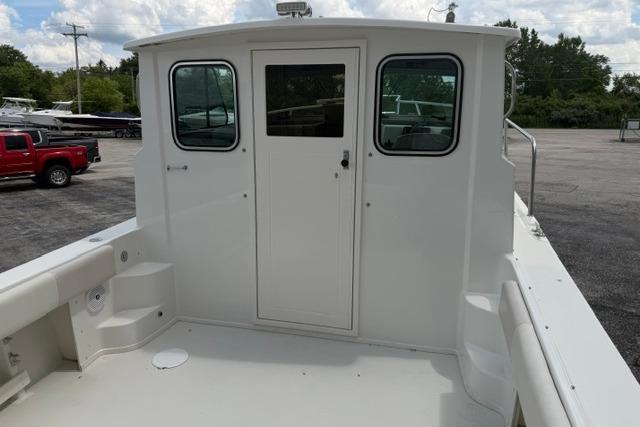 2016 Parker 2520 Sport Cabin boat, rear view with cabin door and windows.