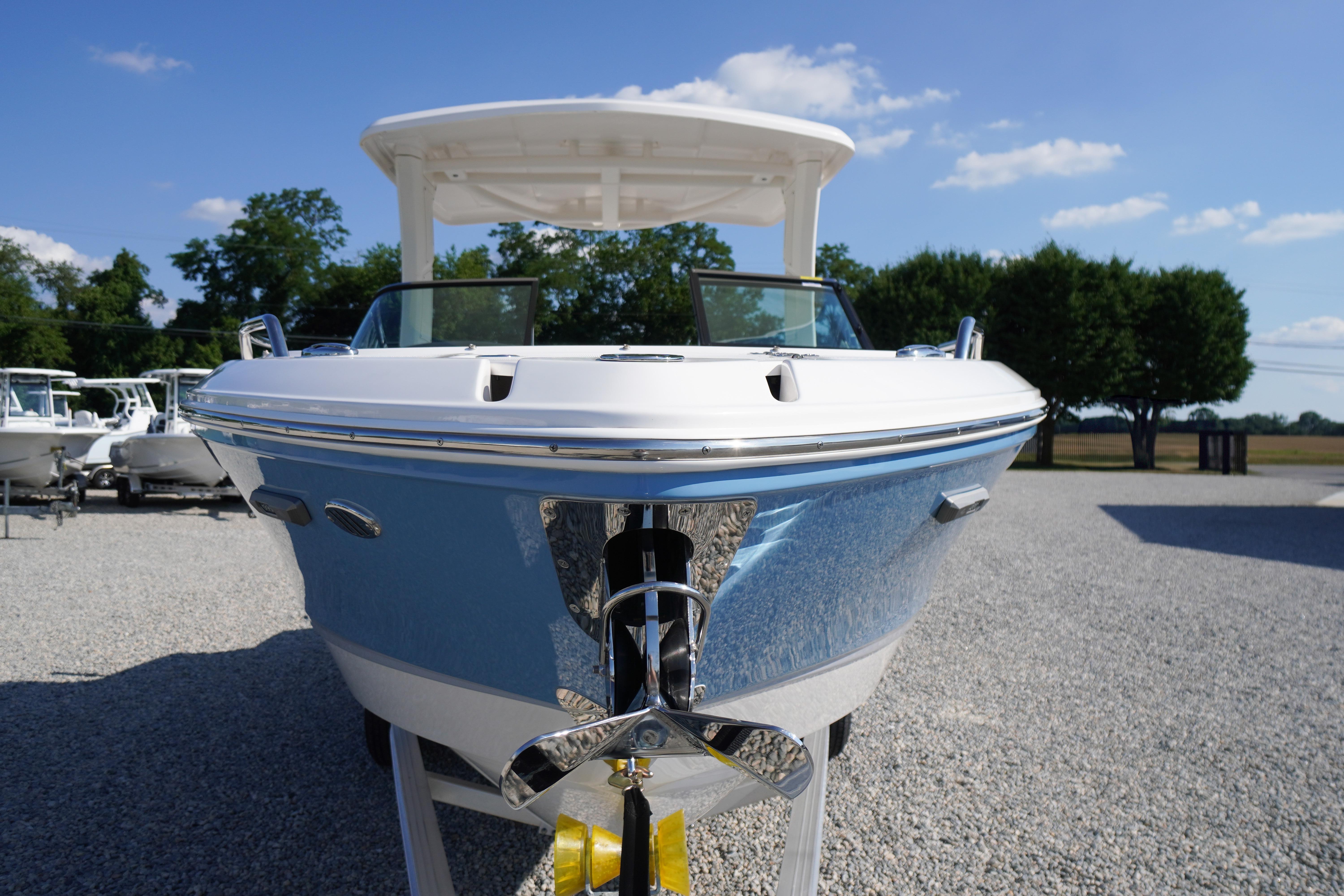 2026 Chaparral 270 OSX boat displayed outdoors on gravel lot.