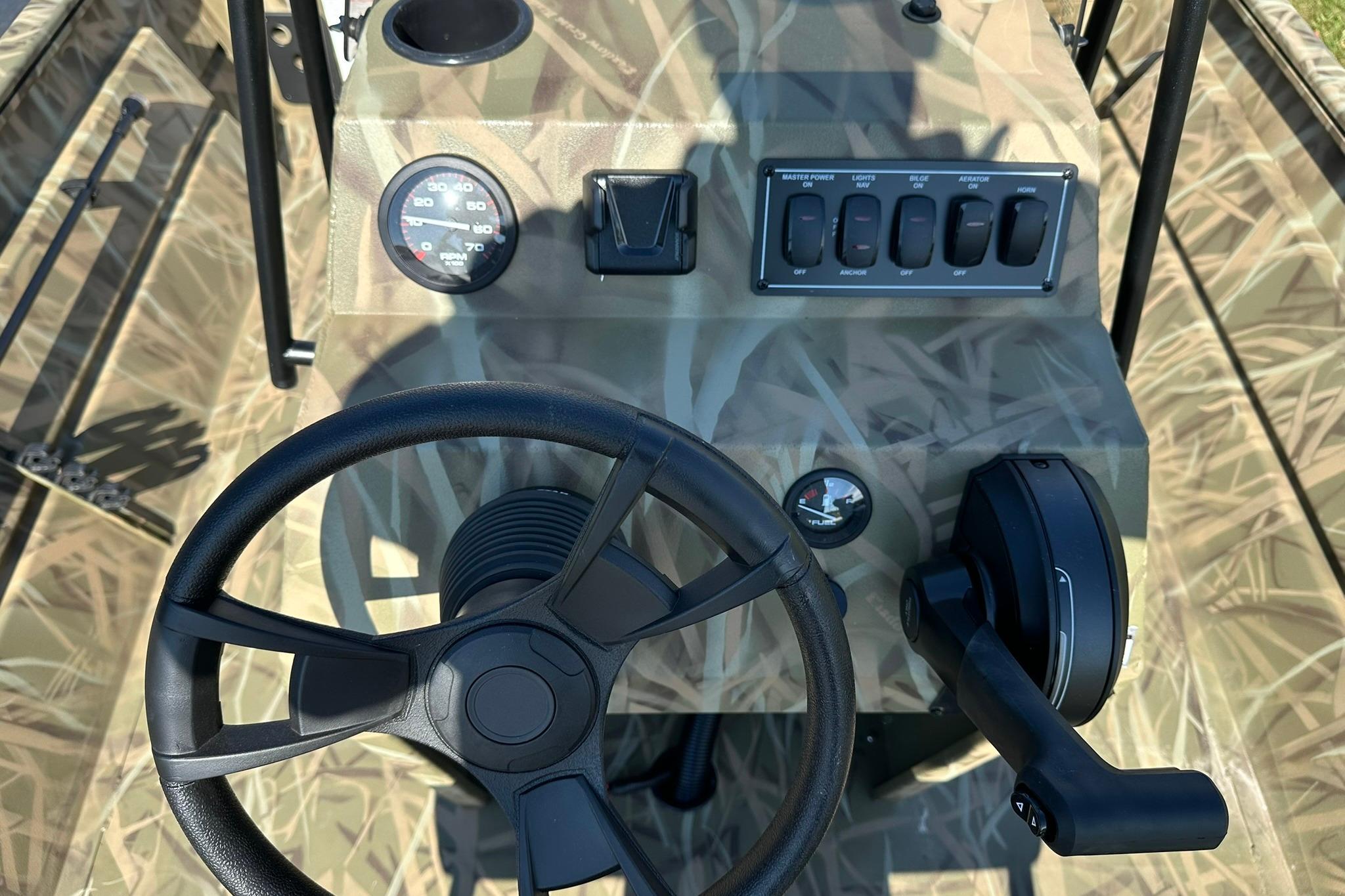 2026 Lowe Roughneck 2070CC boat console with steering wheel and control panel.