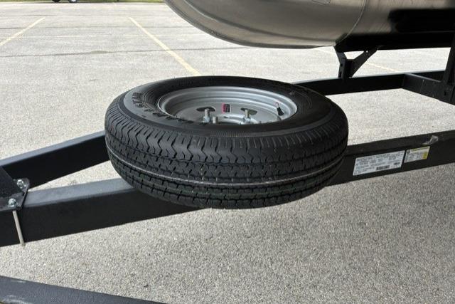 Spare tire mounted on a 2026 Sun Tracker Fishin' Barge 22 DLX trailer.