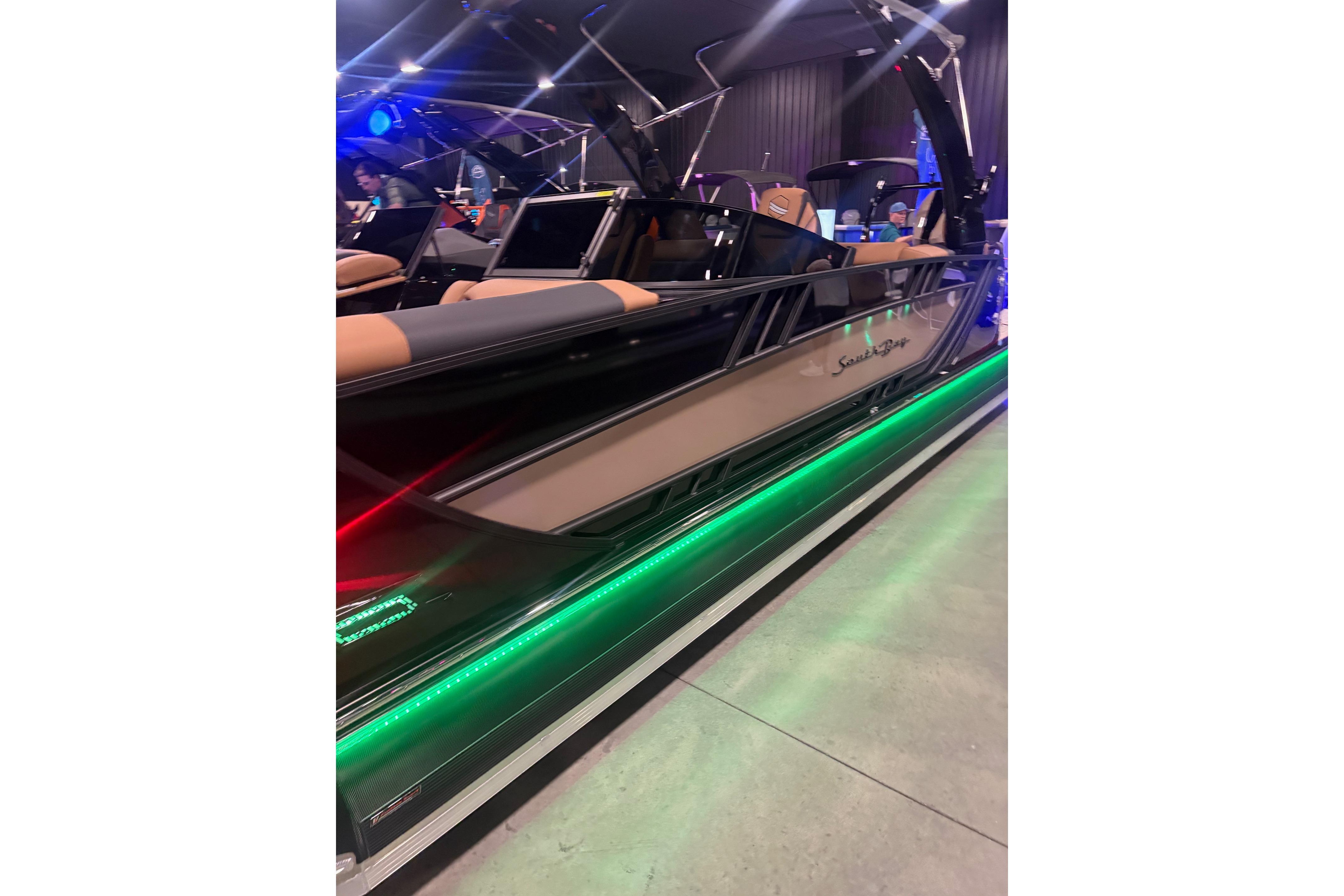 2026 South Bay Sport RS9 DC boat with sleek design and vibrant LED lights.