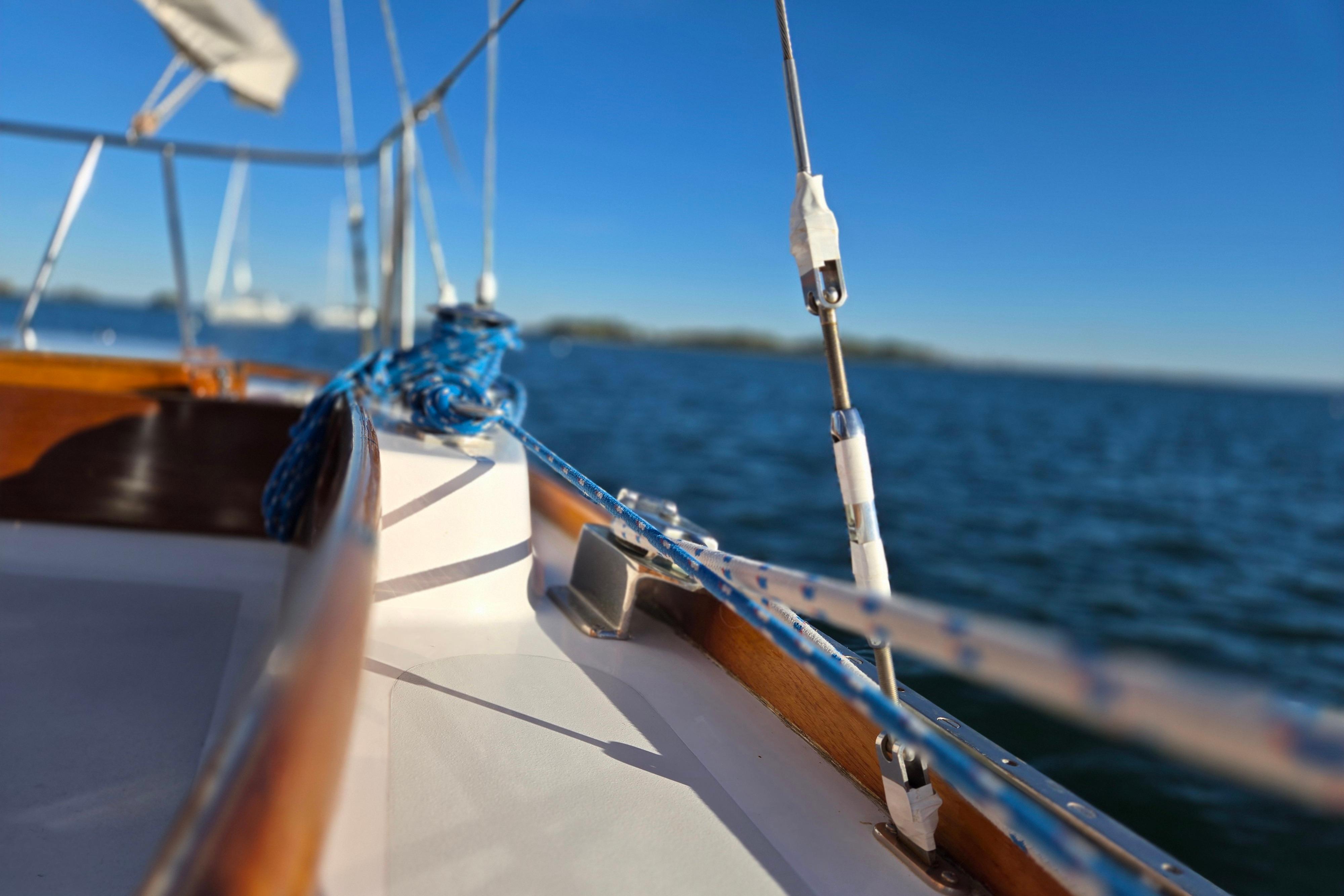 Close-up of 1970 Hinckley Bermuda 40 sailboat deck with blue ropes and ocean view.