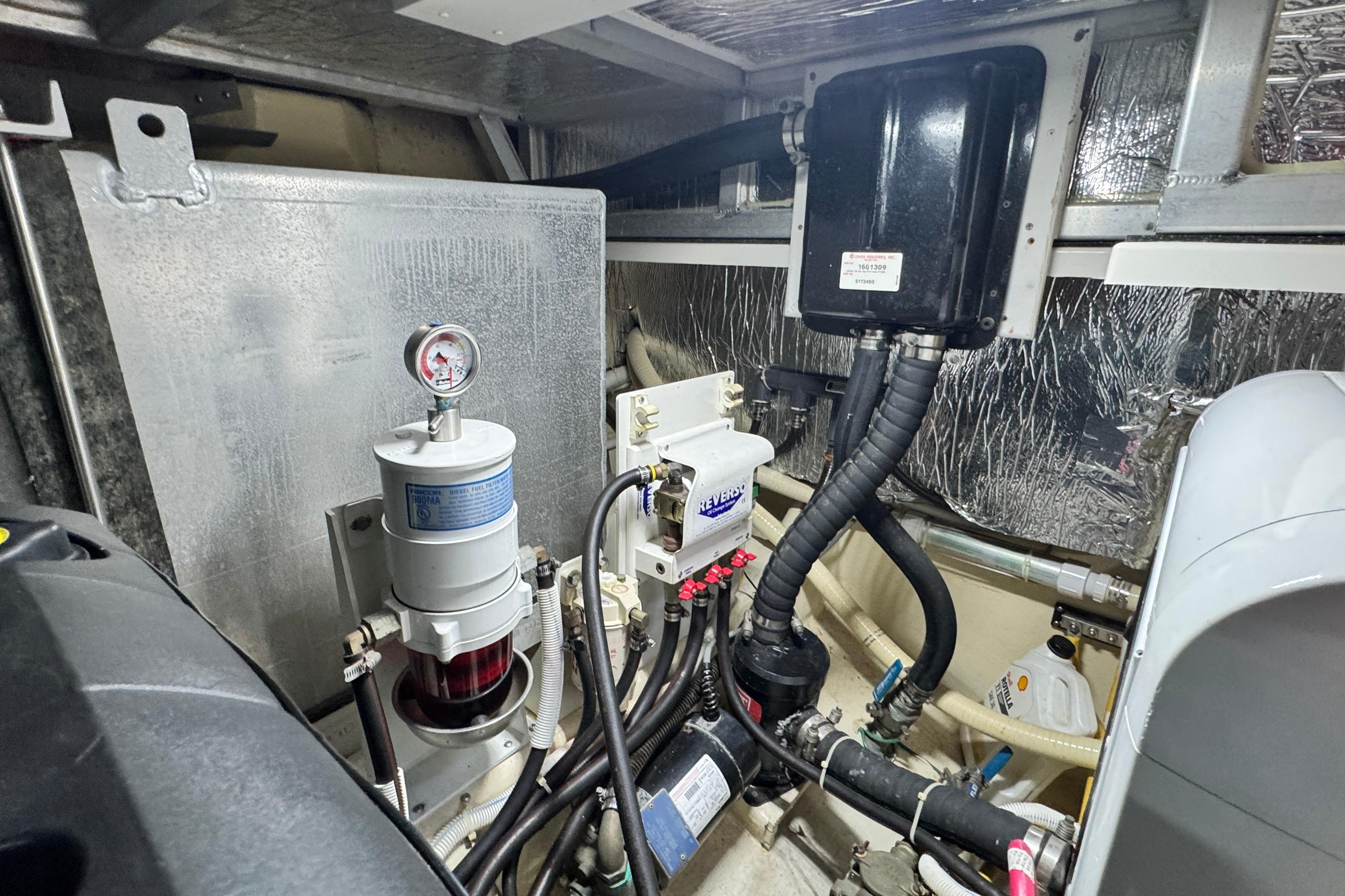 Engine room of 2007 Carver 47 Motor Yacht, showcasing mechanical components and wiring.