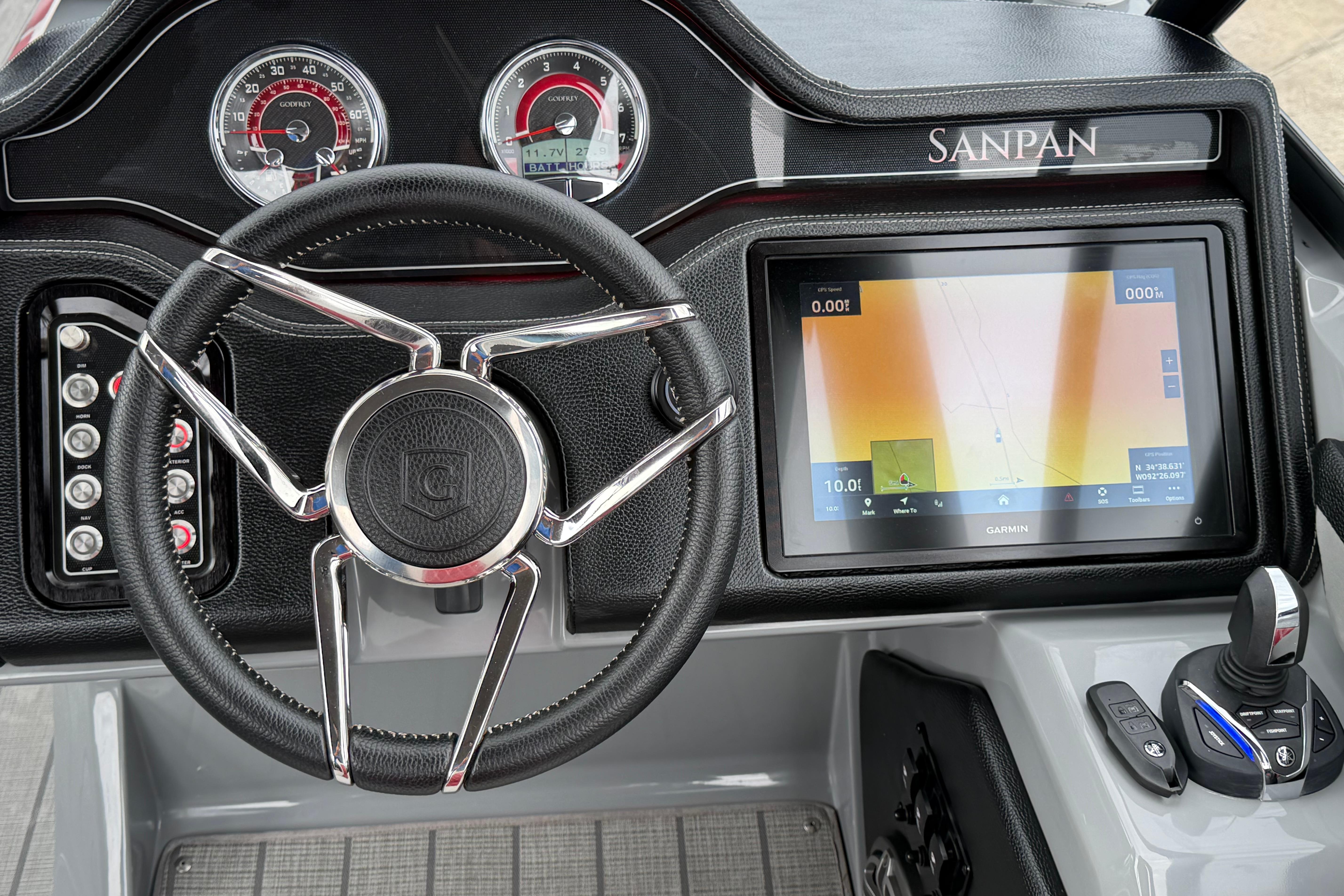 Dashboard of 2023 Godfrey Sanpan 2700 ULW Twin with steering wheel and Garmin display.