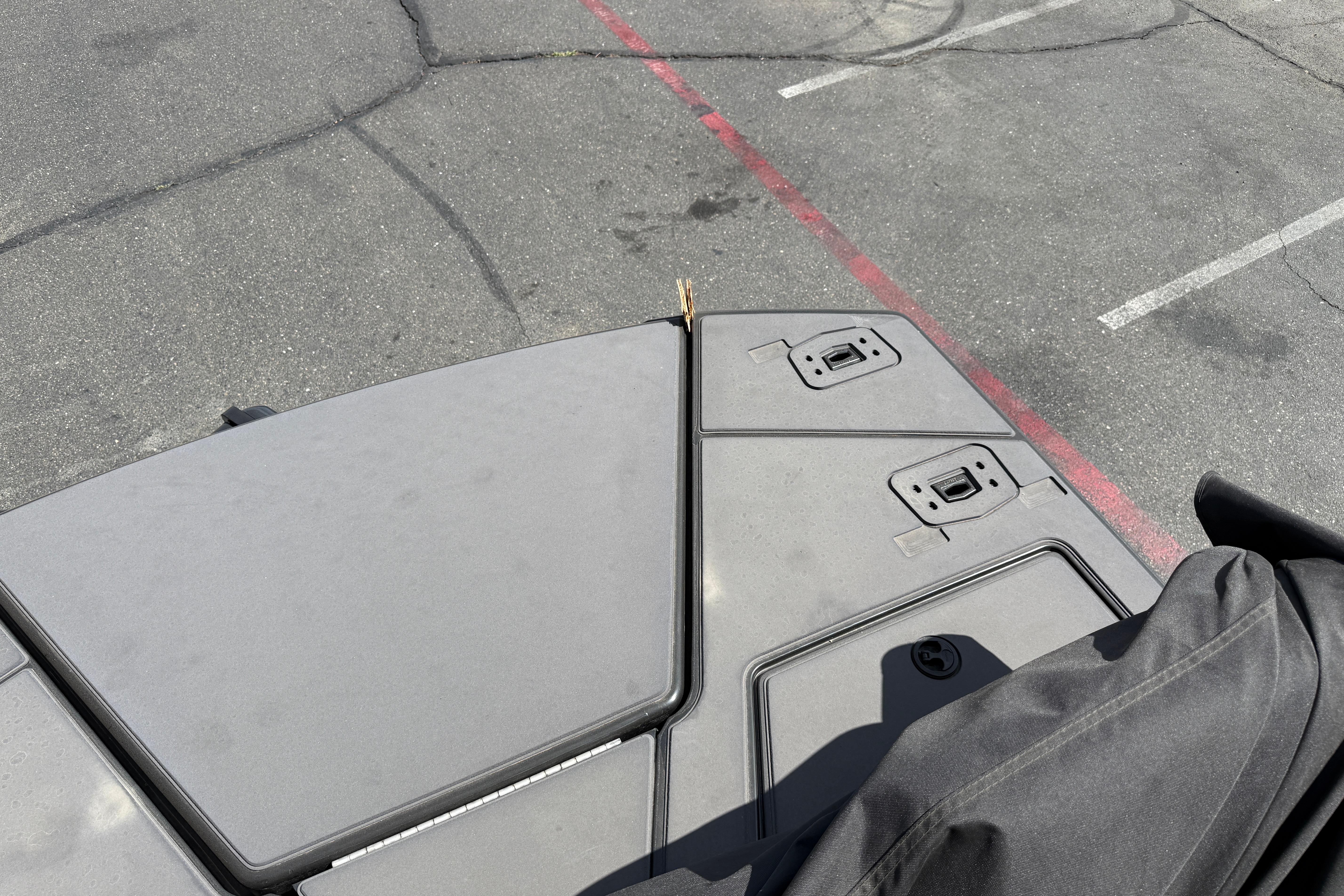 Top view of a 2025 Manitou Cruise boat deck in a parking lot.