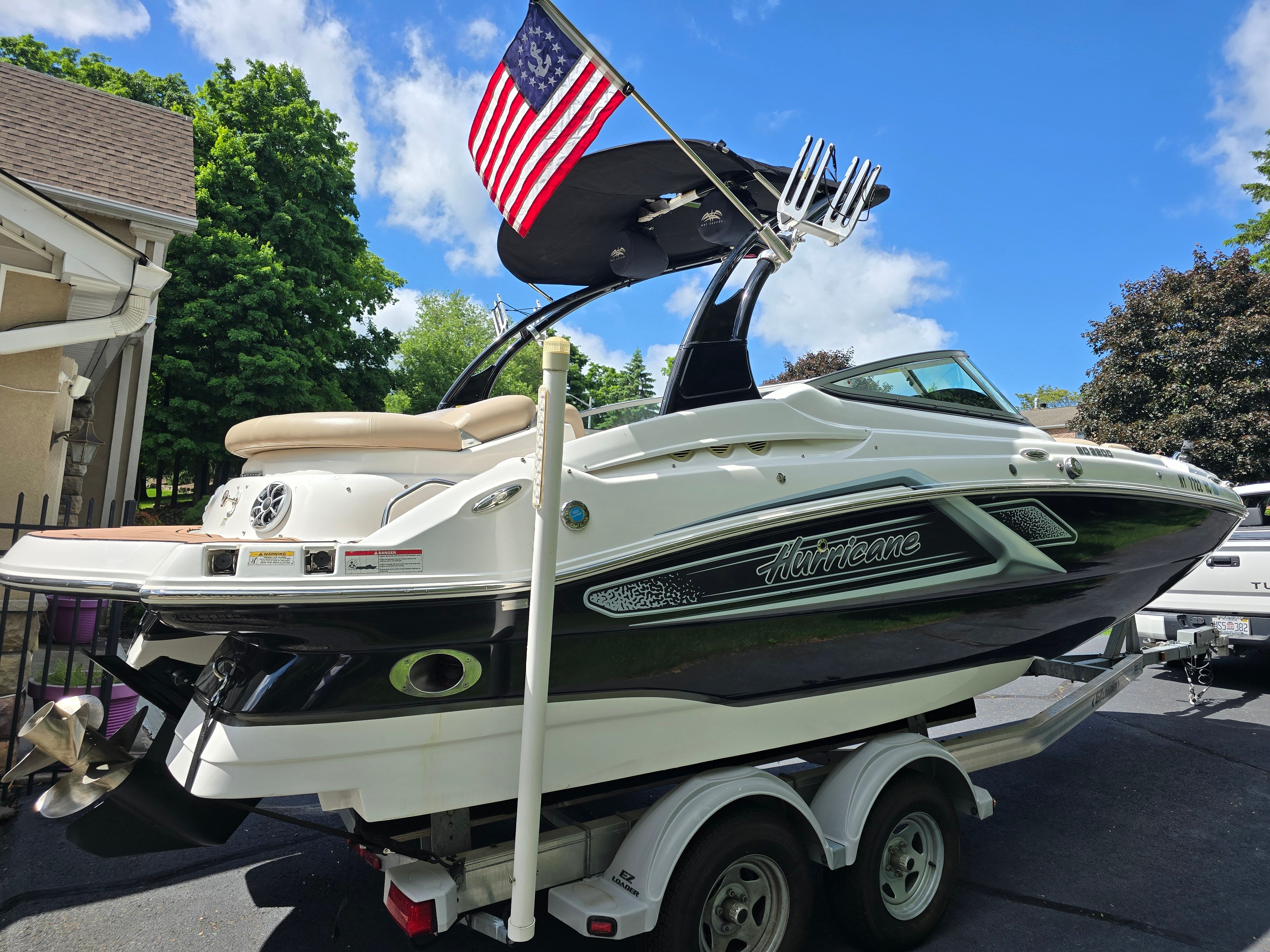 2016 Hurricane SD 2200 boat on trailer with US flag.