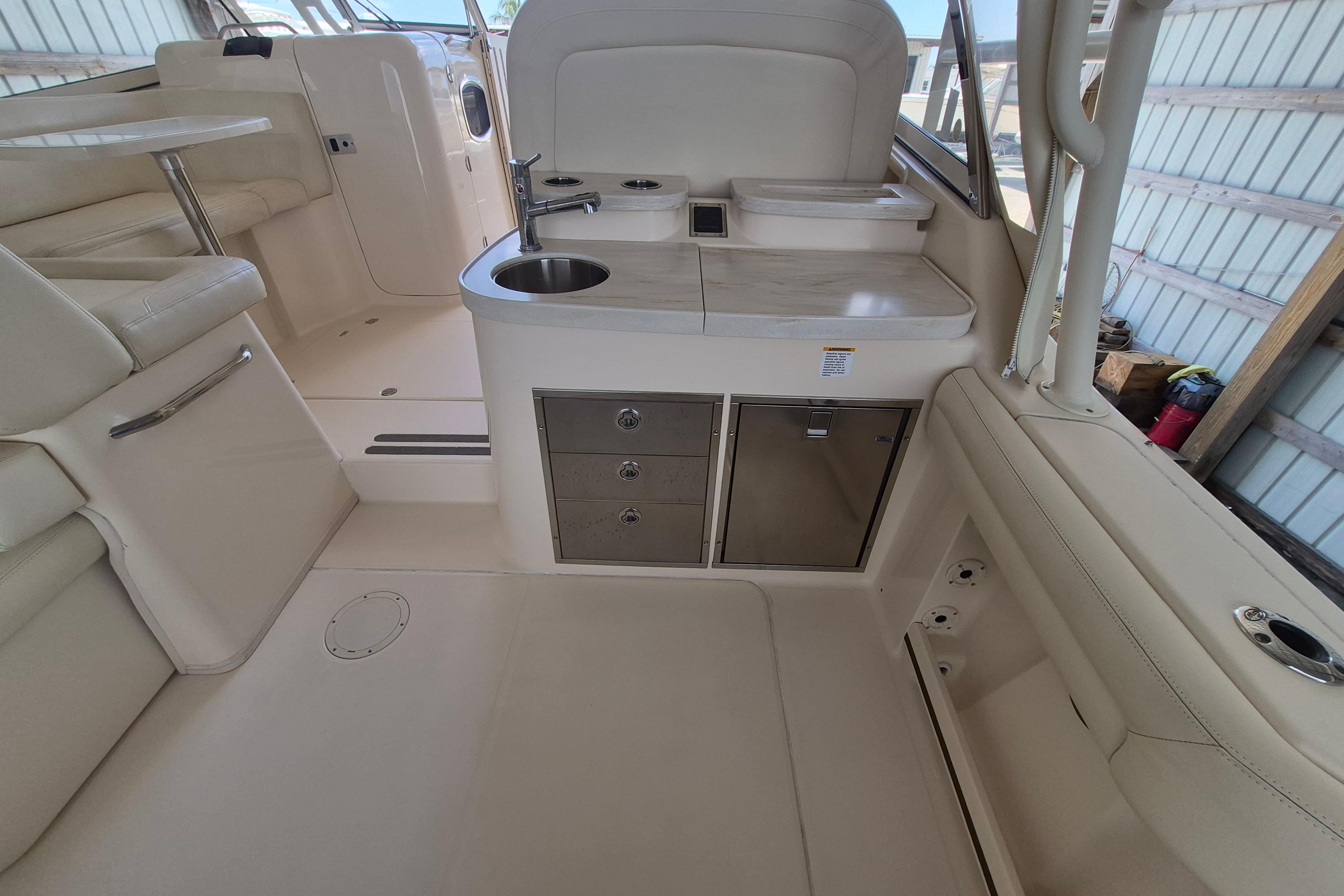 2019 Grady-White Freedom 335 boat interior with kitchenette and seating area.