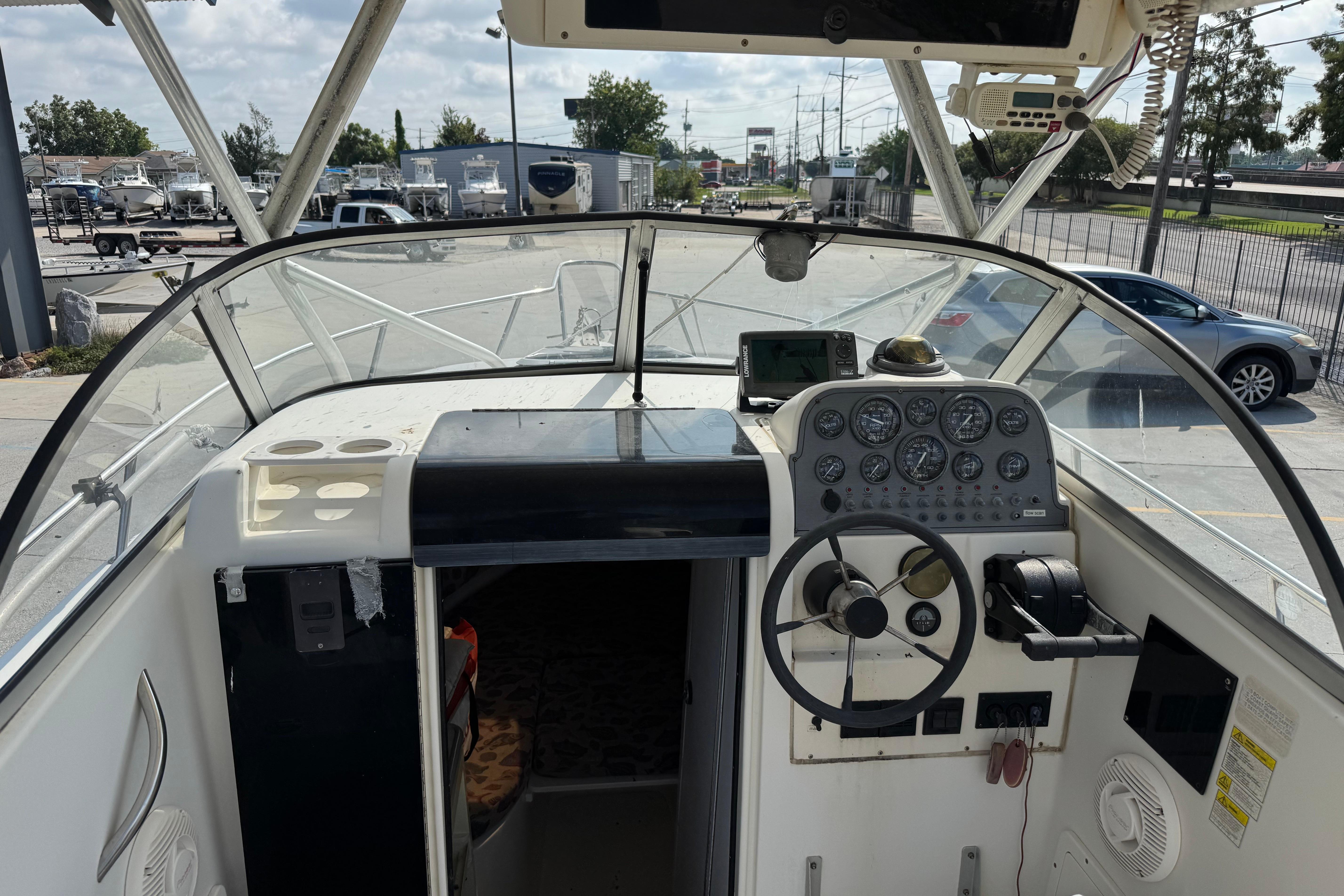 1997 Hydra-Sports VECTOR 2650 WA boat cockpit with steering wheel and instrument panel.
