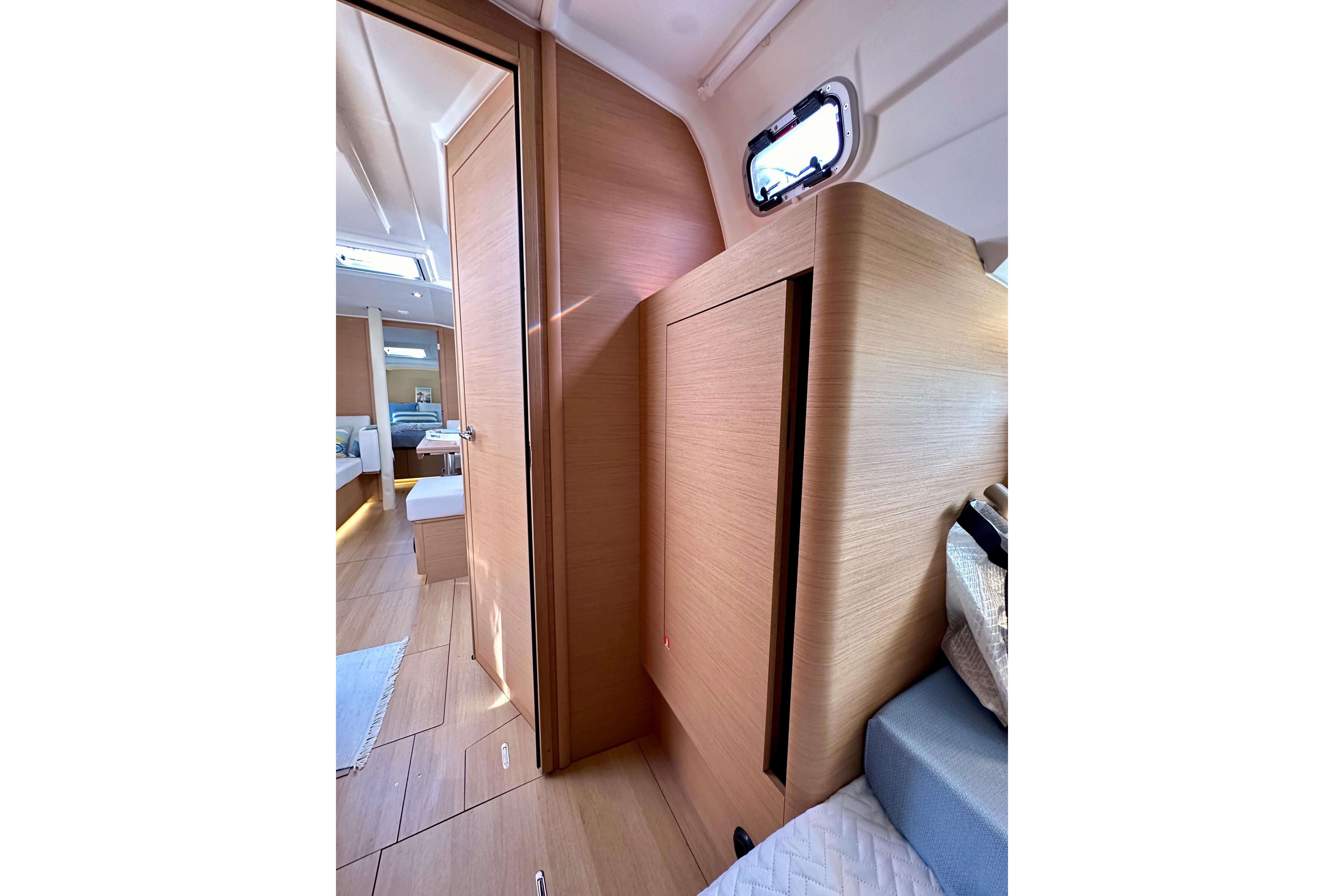 Interior of 2024 Jeanneau Sun Odyssey 410 yacht, featuring modern wood finishes and cozy cabin space.