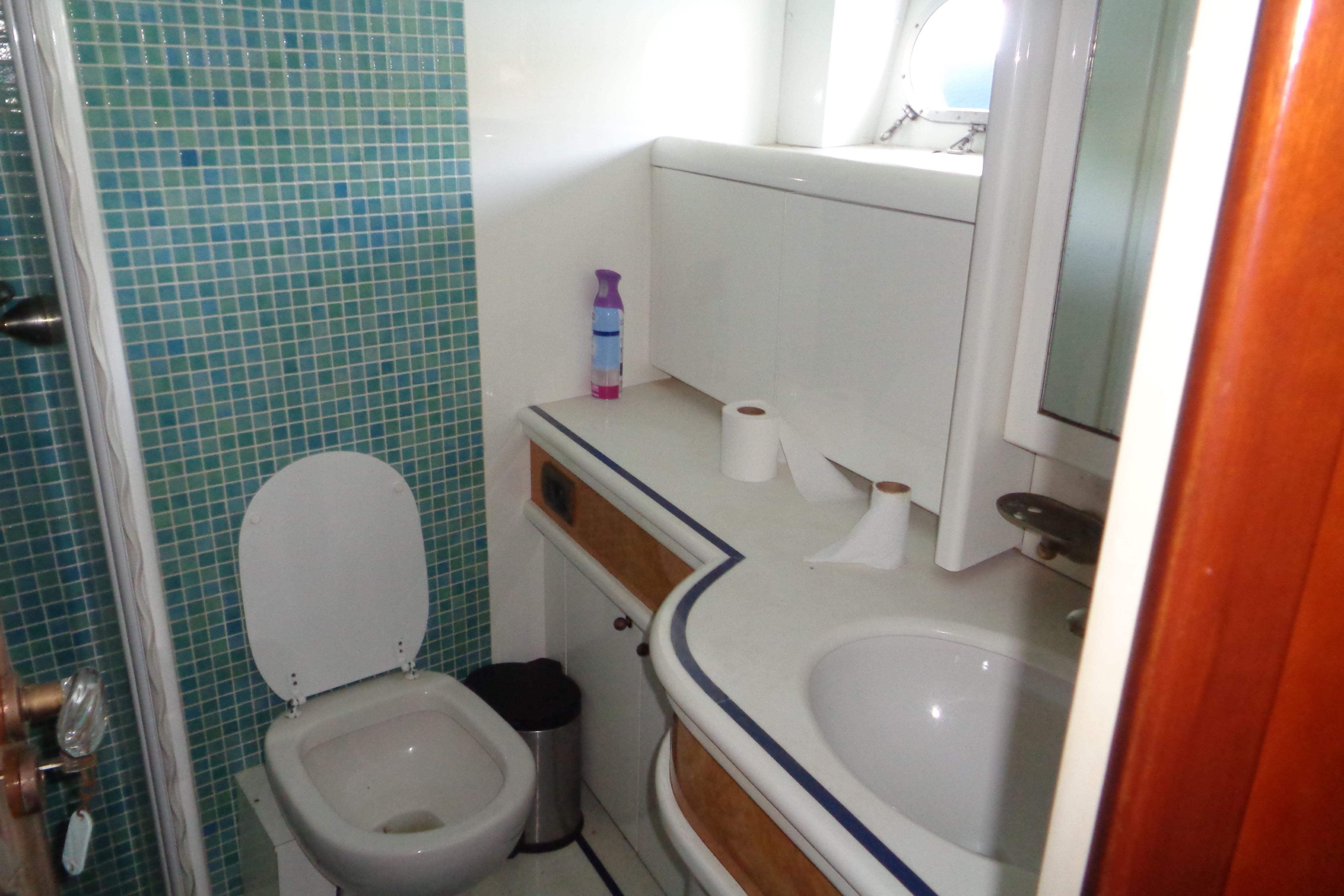 Bathroom interior of 1995 Azimut 78 Ultra Motoryacht with mosaic tiles and modern fixtures.