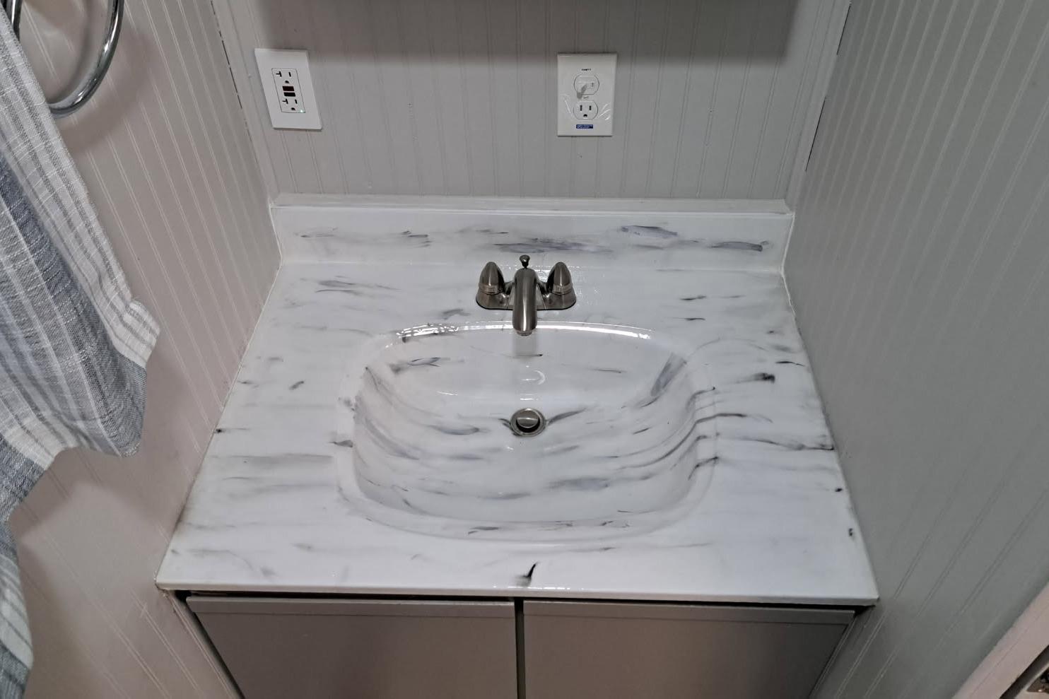 Marble sink countertop in a Sumerset 16 x 70, 1990 model houseboat bathroom.