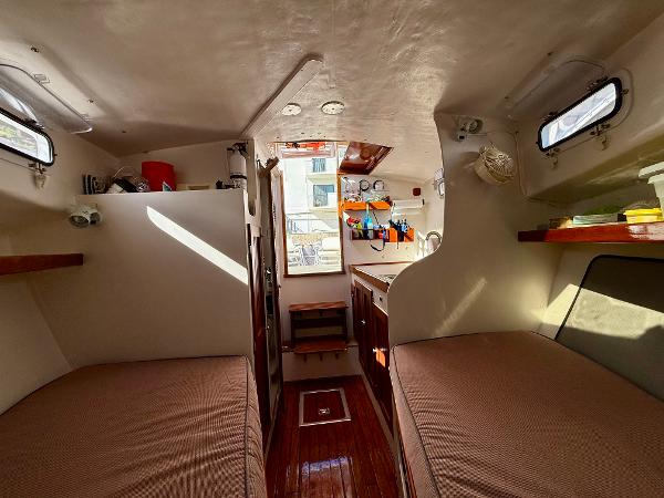Interior of a 1978 Dyer 29 Trunk Cabin boat with cozy sleeping quarters.