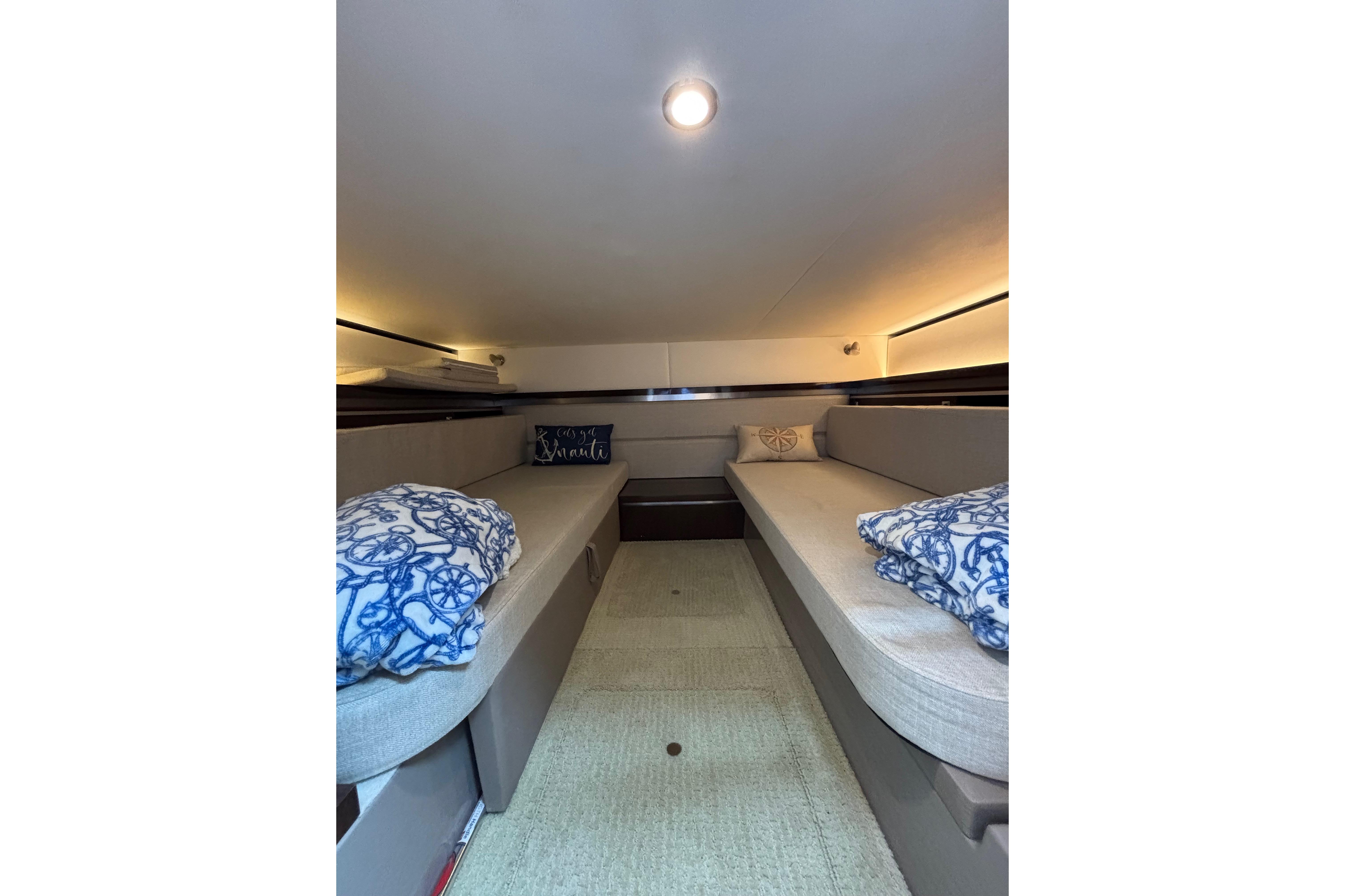 Interior cabin of 2021 Sea Ray Sundancer 320 Outboard with cozy seating and nautical decor.