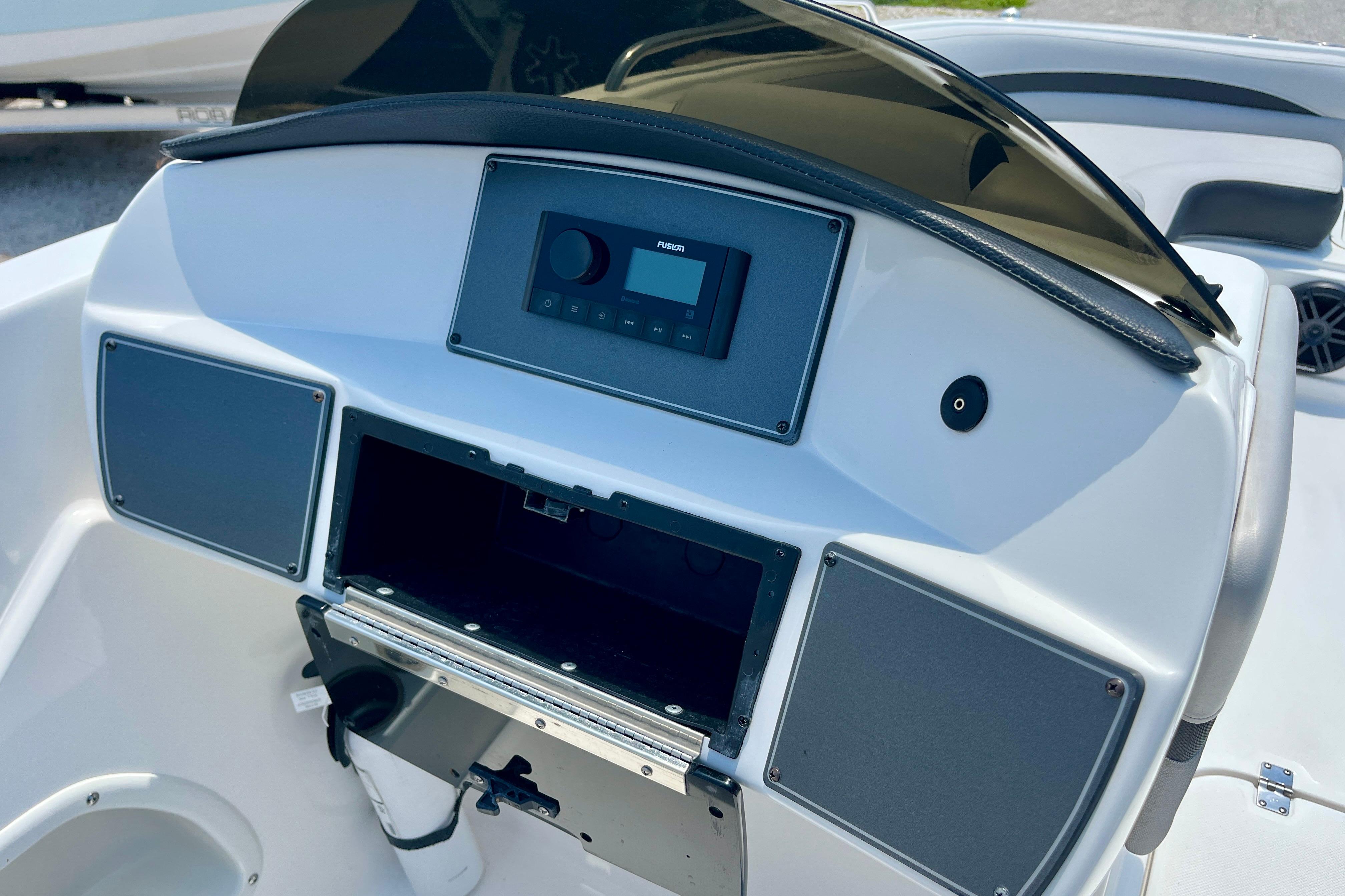 2024 Hurricane Sundeck Sport 218 OB dashboard with stereo system and storage compartment.