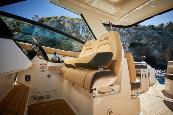 Manufacturer Provided Image: 2023 Sea Ray Sundancer 320 helm with luxurious seating and scenic coastal backdrop.