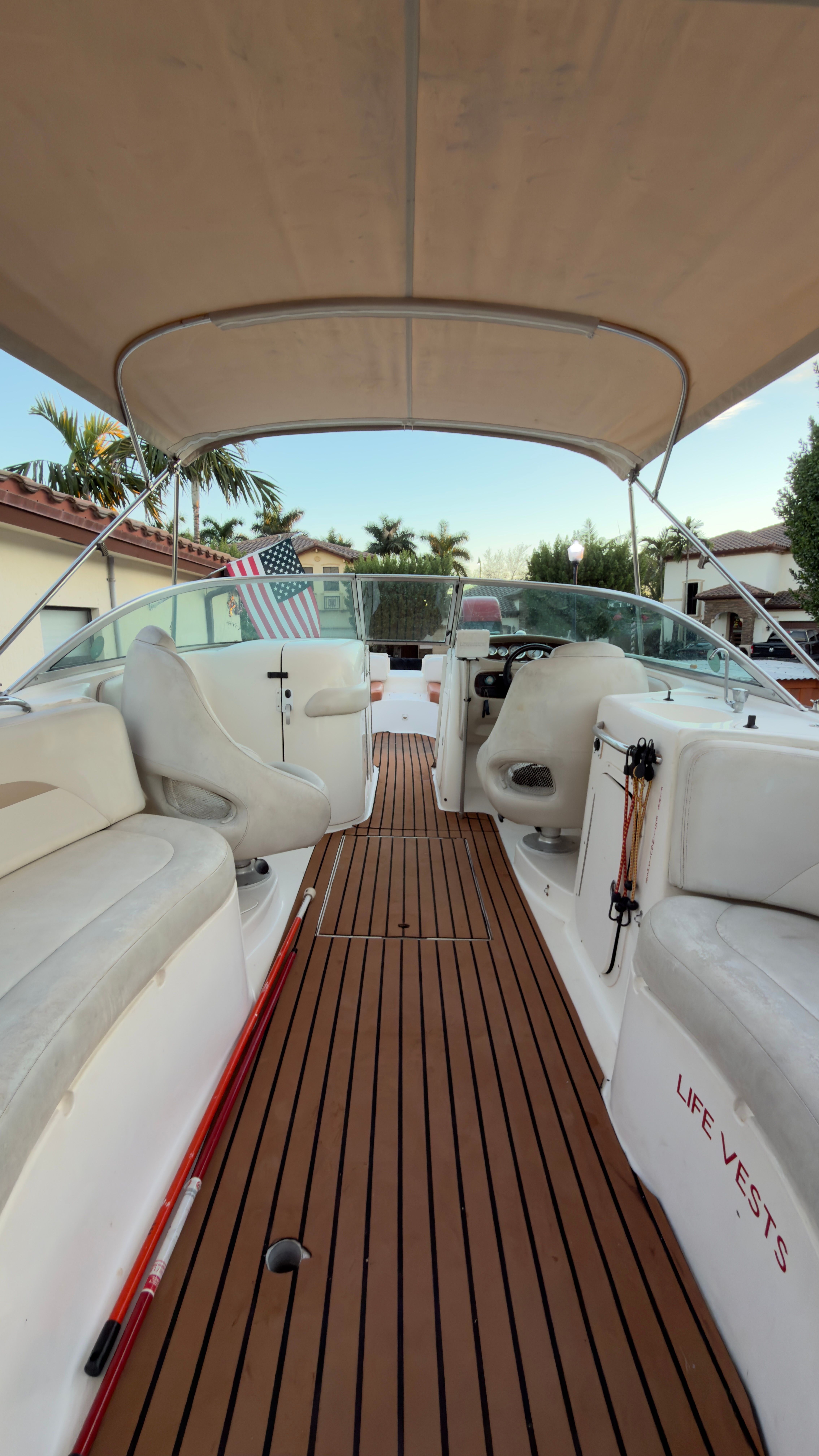 Interior view of a 2003 Chaparral 263 Sunesta Deckboat with wooden flooring.