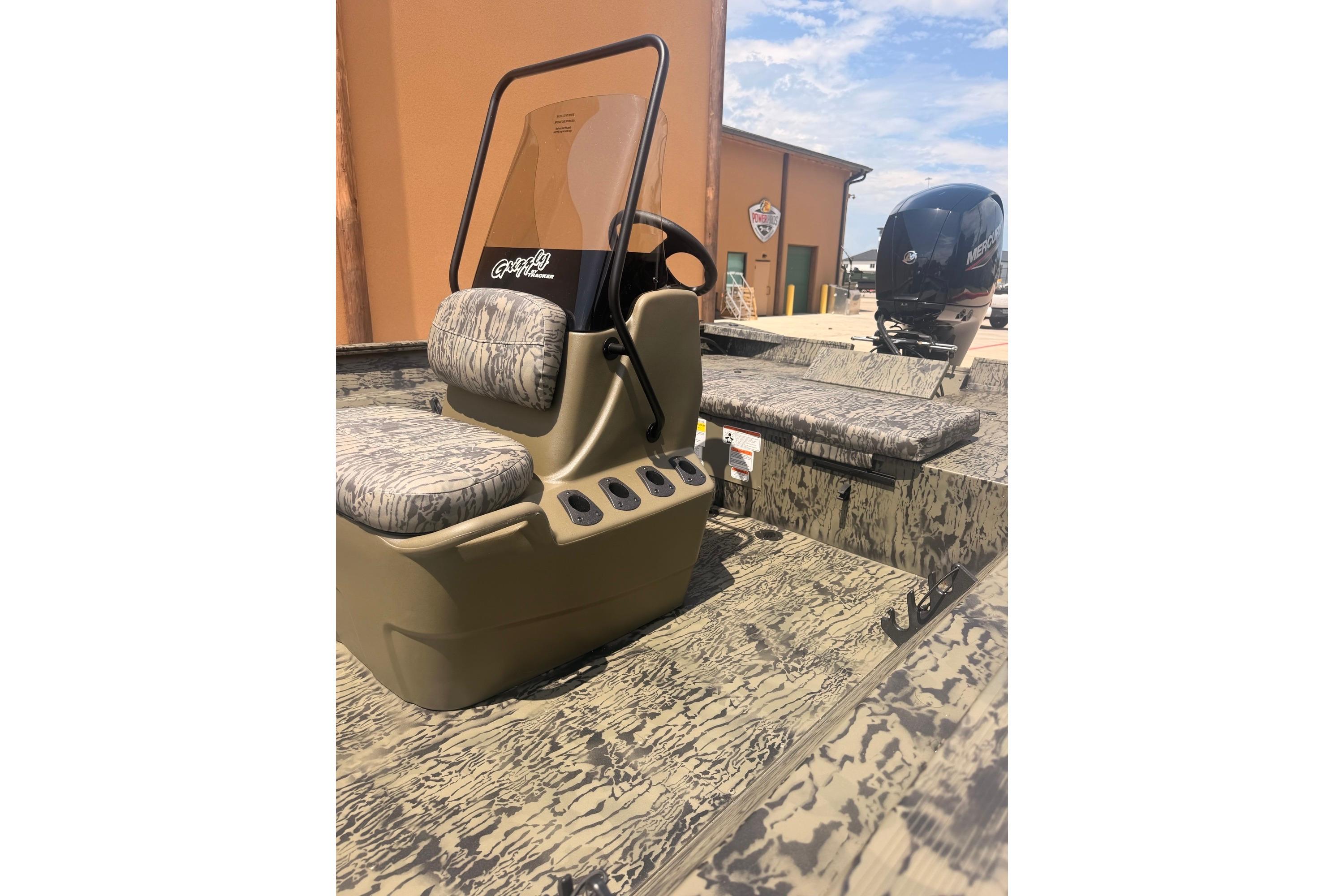 2026 Tracker Grizzly 2072 CC boat with camouflage seating and Mercury outboard motor.