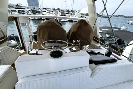 Cockpit view of a 1980 Viking 43 Convertible yacht docked at a marina.