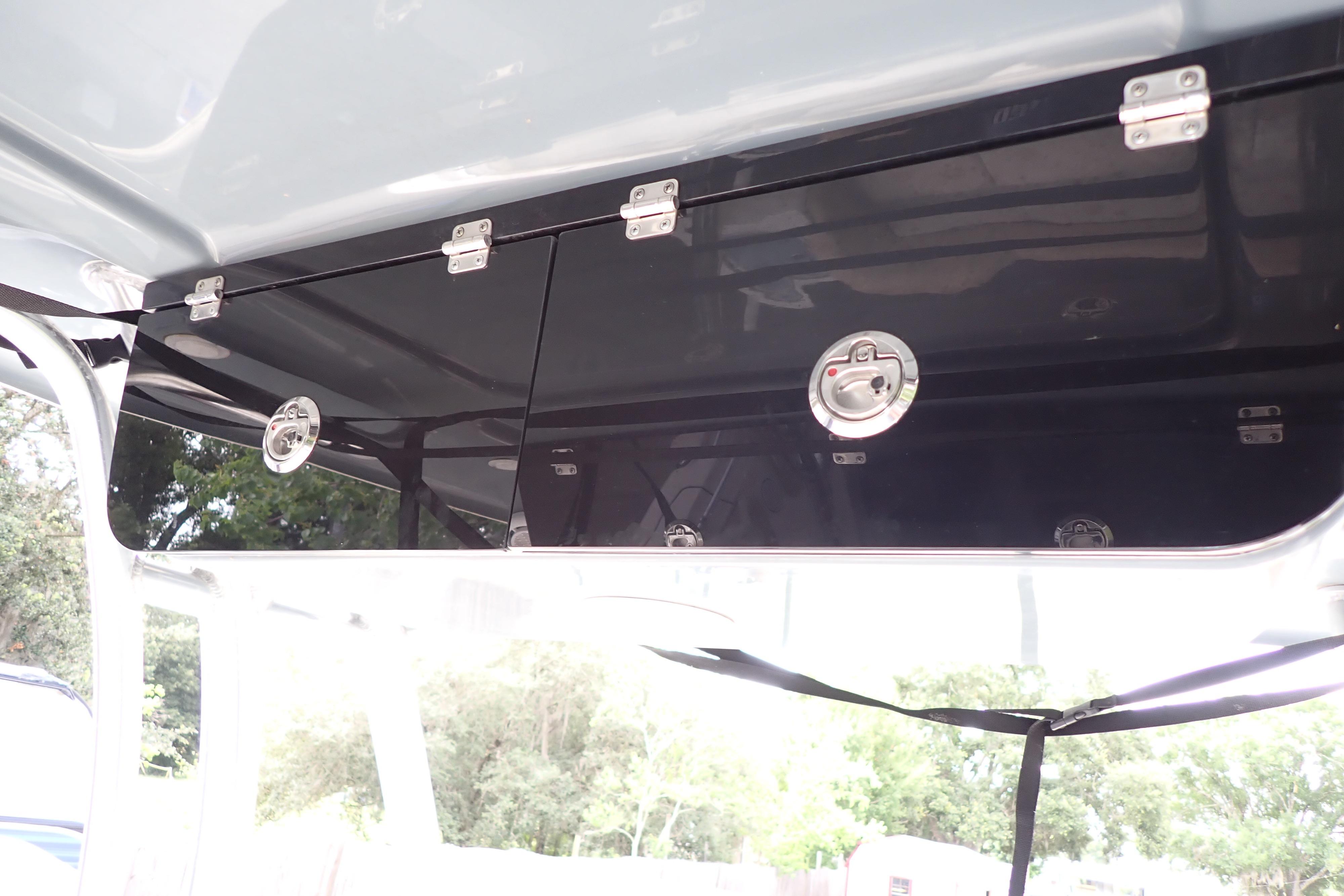 2019 Key West 263 FS boat storage compartment with secure latches and sleek design.