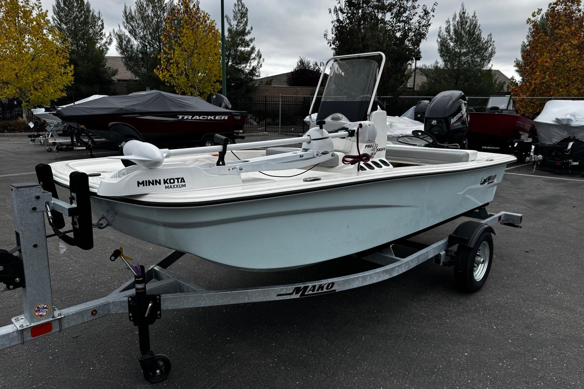 2026 Mako Pro Skiff 13 CC boat on trailer, featuring Minn Kota Maxxum motor.