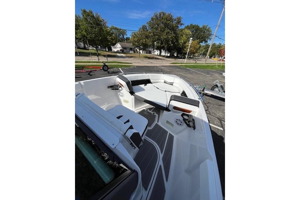 2026 Monterey Elite 27 SD boat interior with seating and cup holders, parked outdoors.