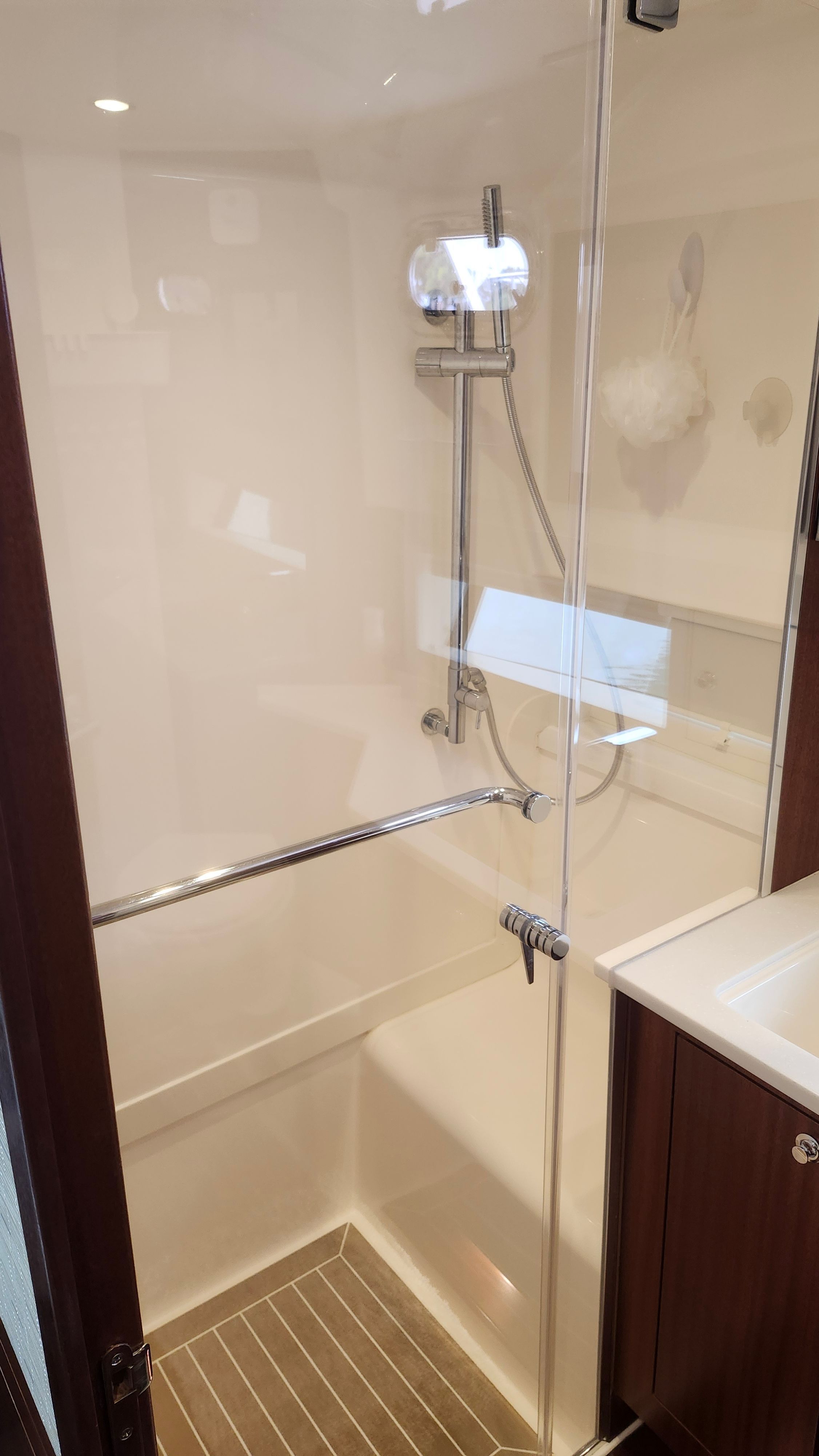 The shower in the Pursuit OS 445 Offshore cabin is modern and elegantly designed.