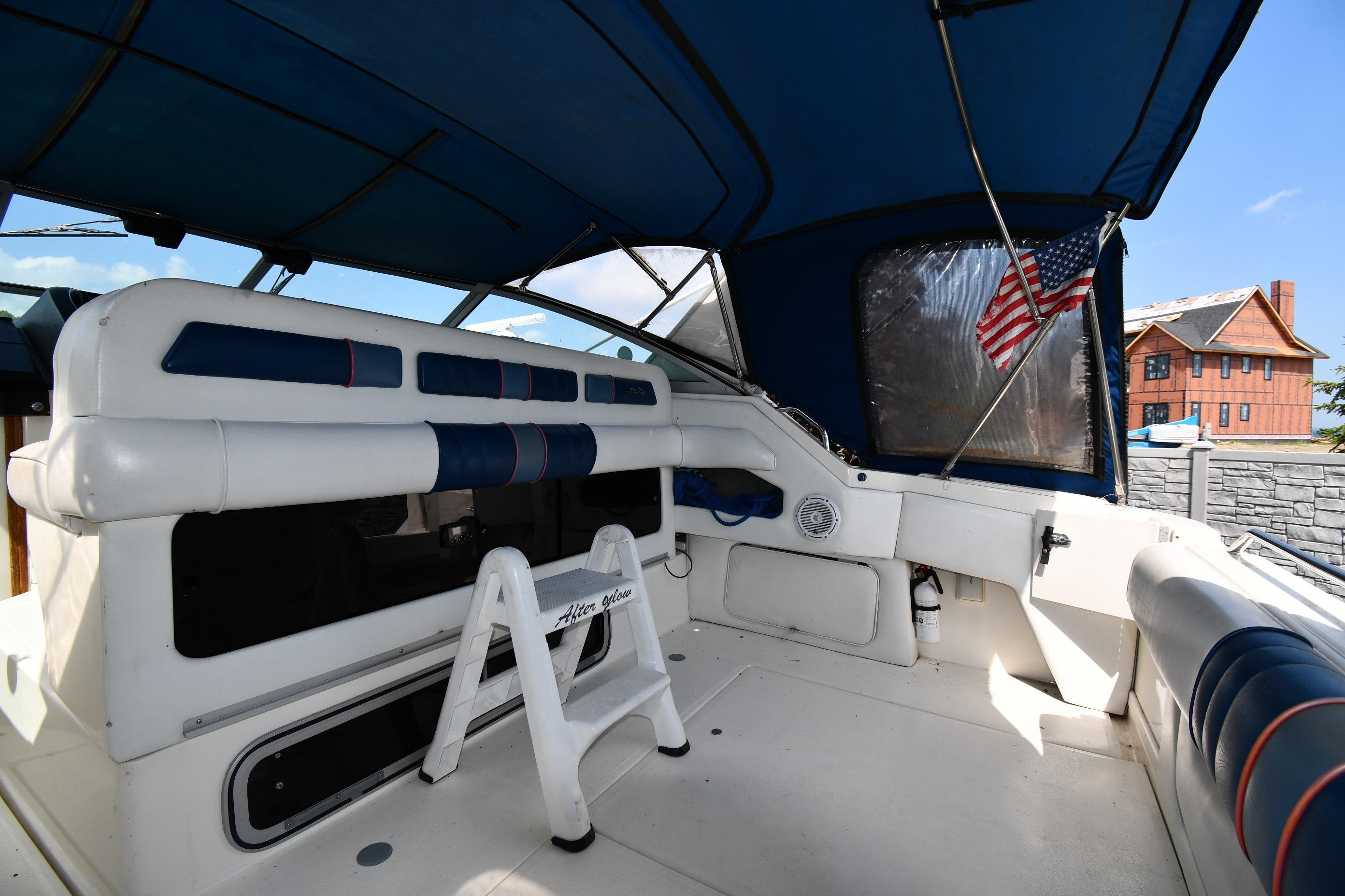 1993 Sea Ray 300 Sundancer interior with blue canopy and American flag.