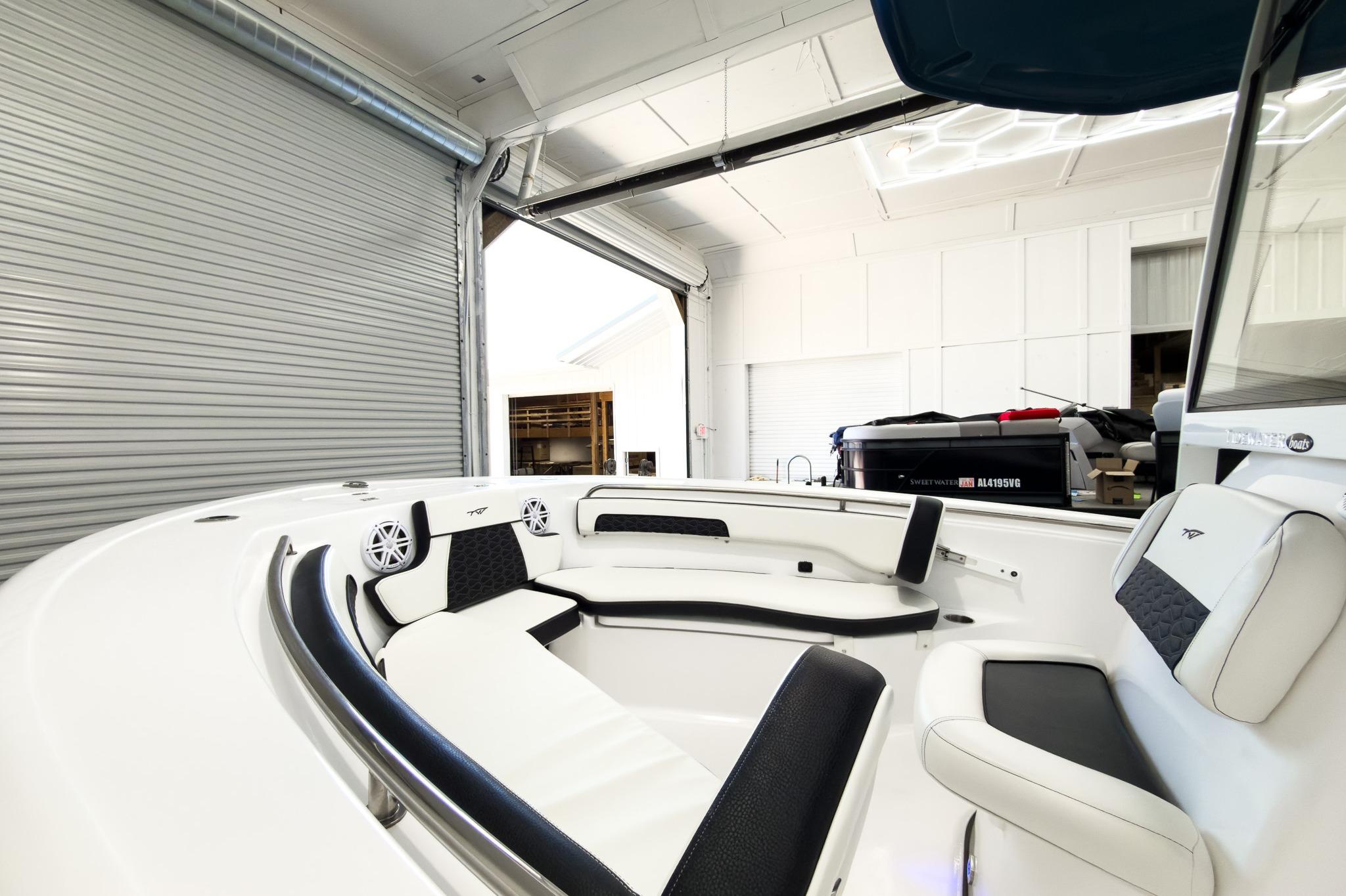 The image shows the interior of a 2026 Tidewater 220 LXF boat in a garage.