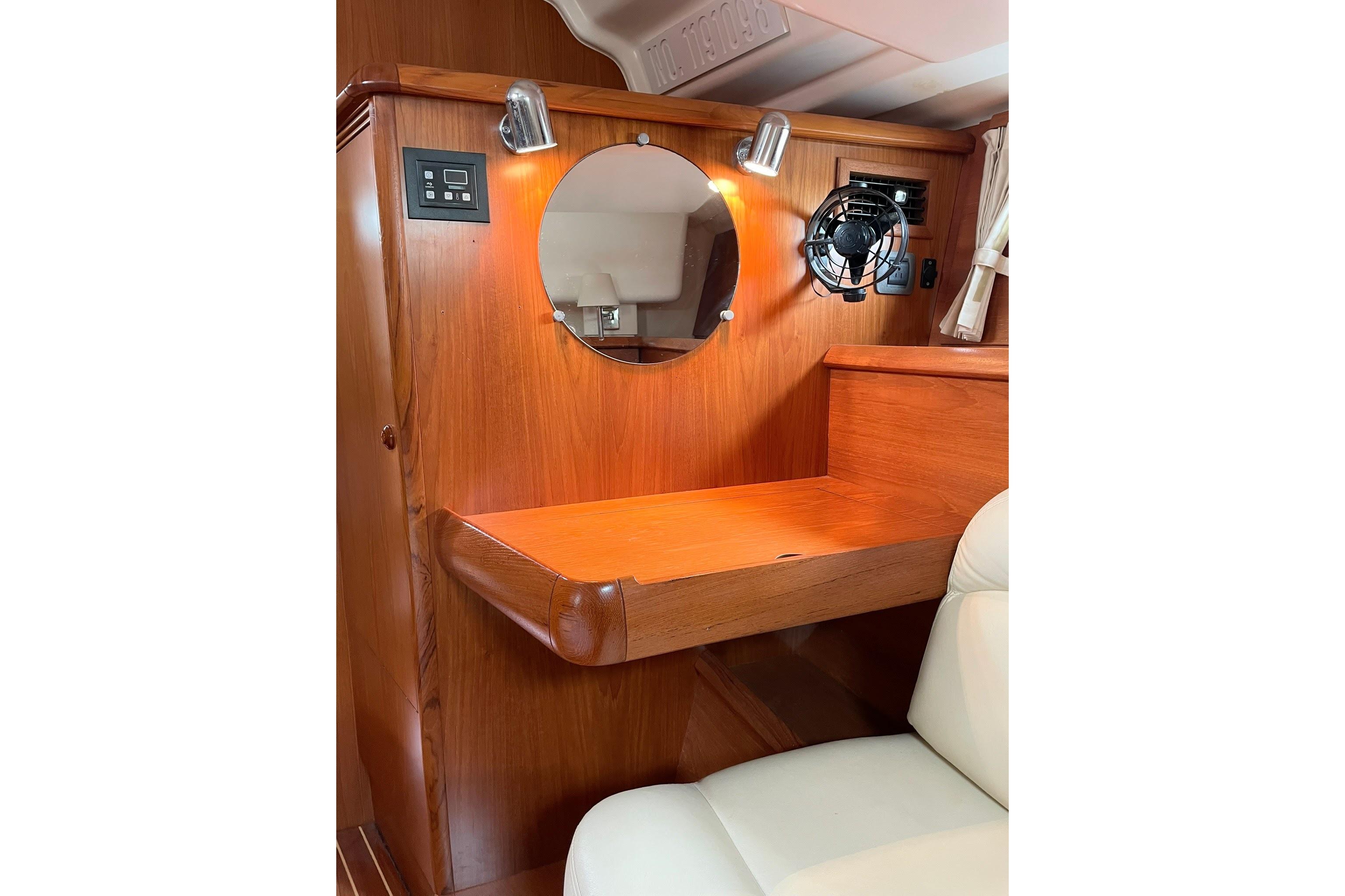 Wooden cabin interior of 2007 Jeanneau Sun Odyssey 54 DS with mirror and fan.