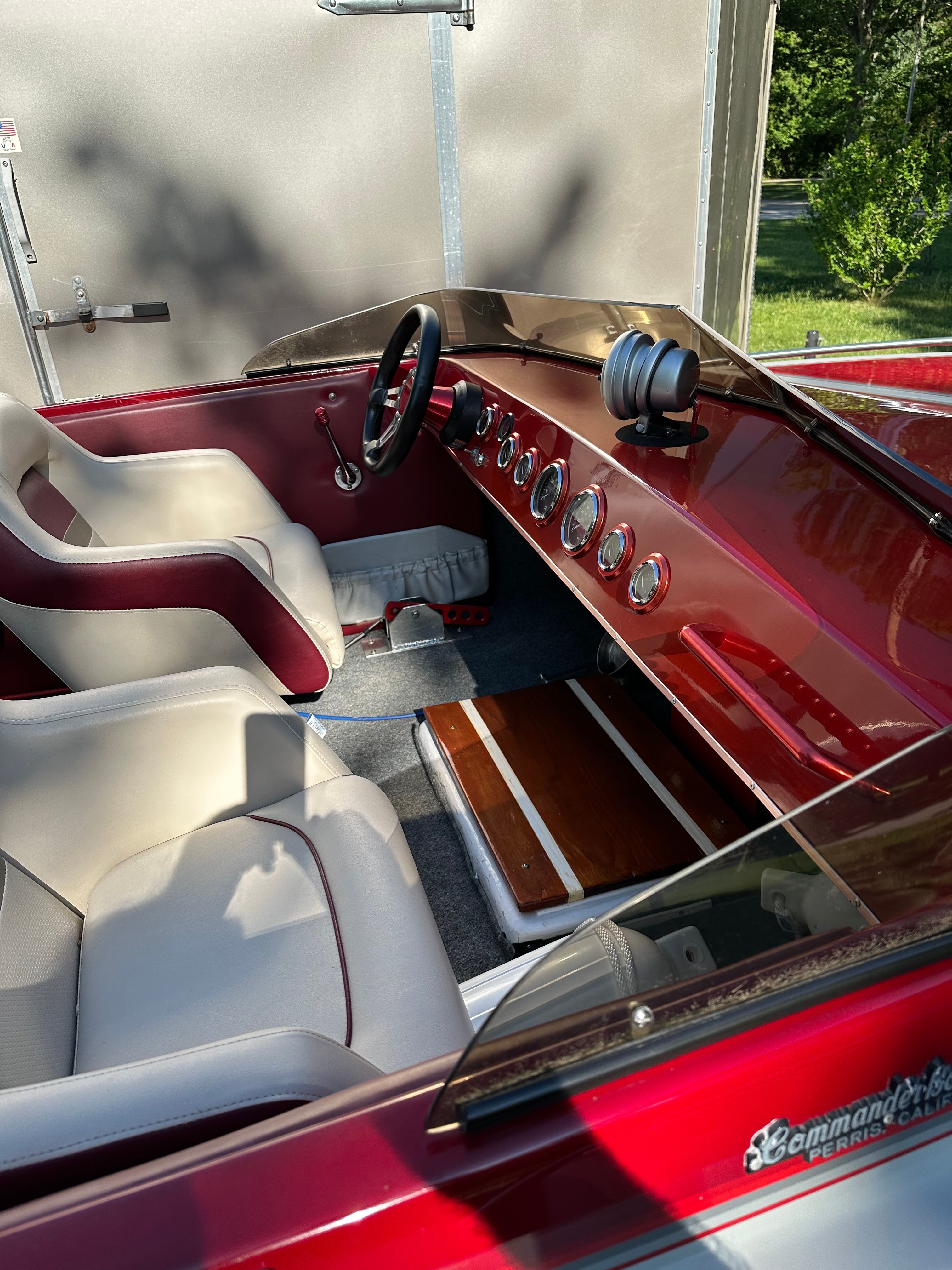 Interior of a red 1989 Custom Jet Boat with white seats.