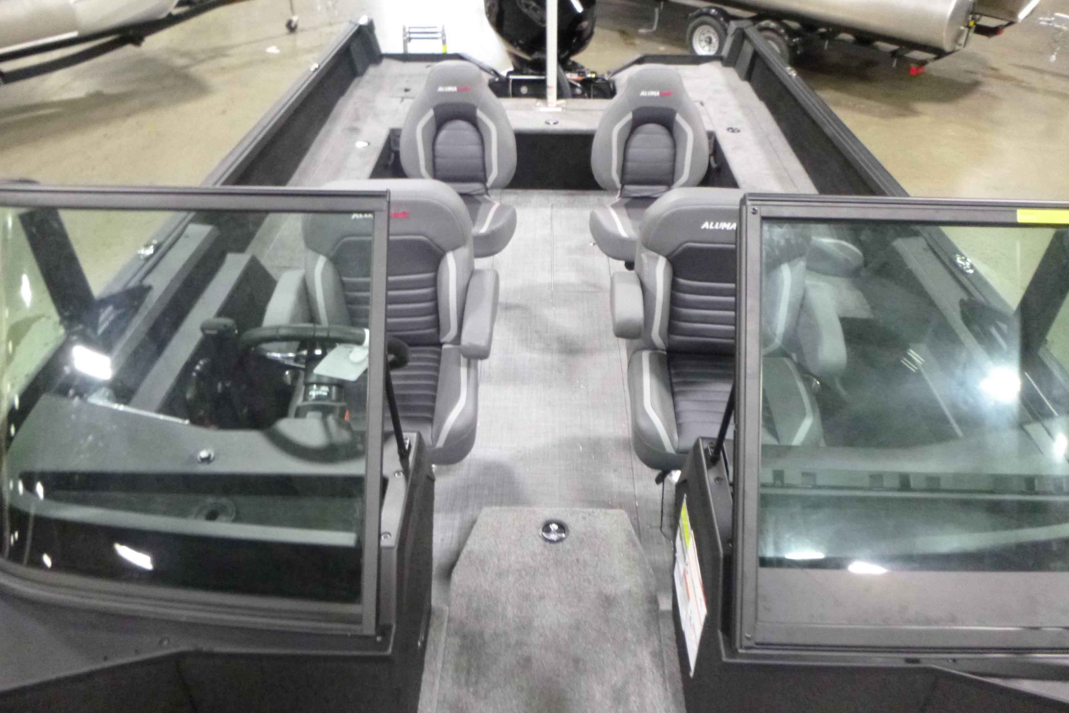 2026 Alumacraft Competitor 205 Sport boat interior with four seats and windshield.