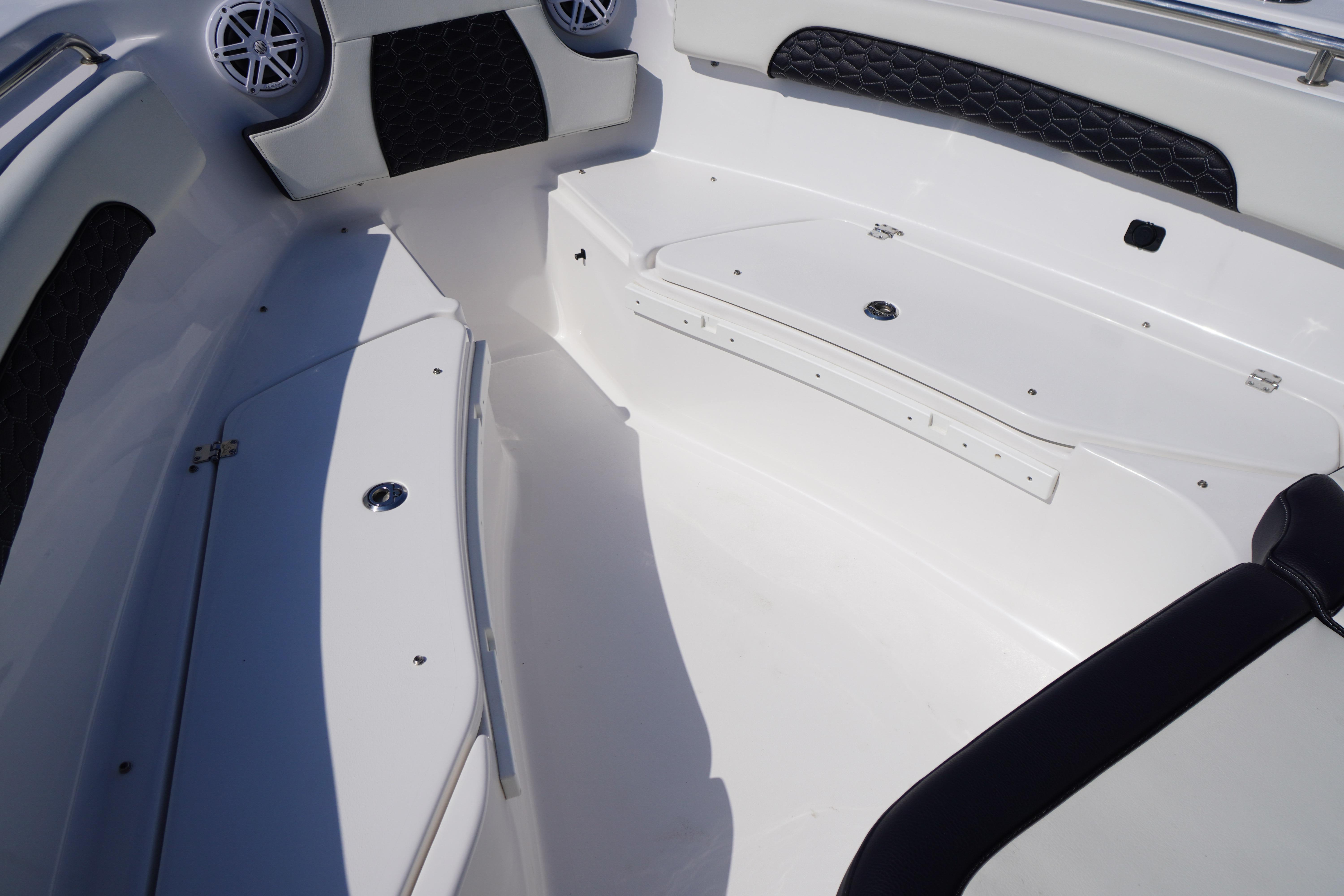 2025 Tidewater 232 SS boat interior with sleek seating and storage compartments.