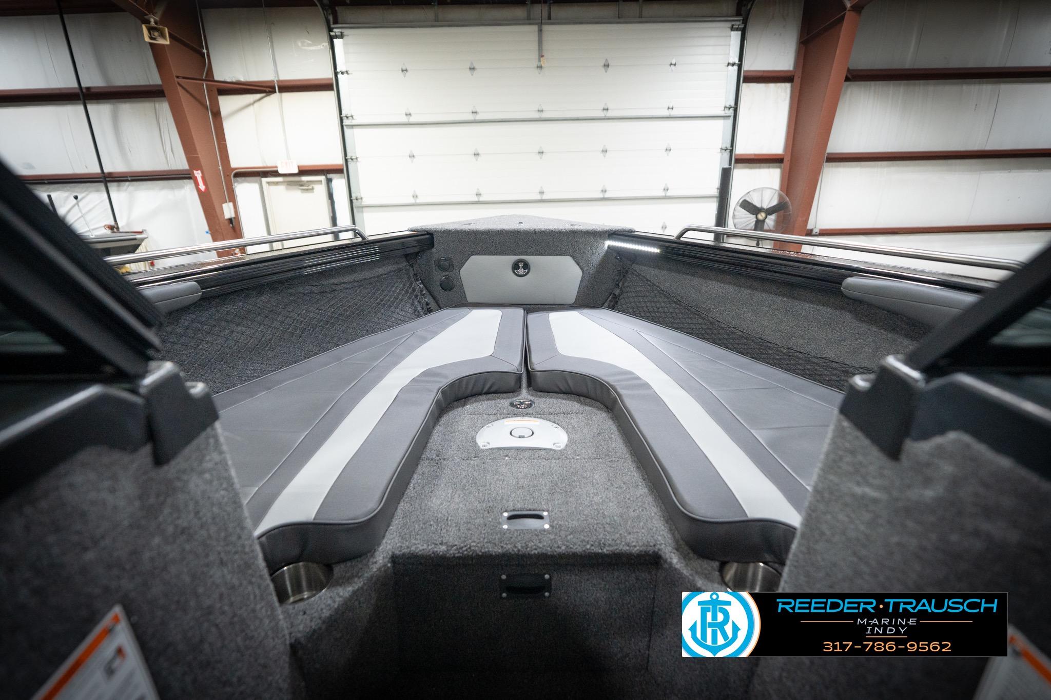 2026 Lund 2275 Baron boat interior with gray seating in a garage setting.