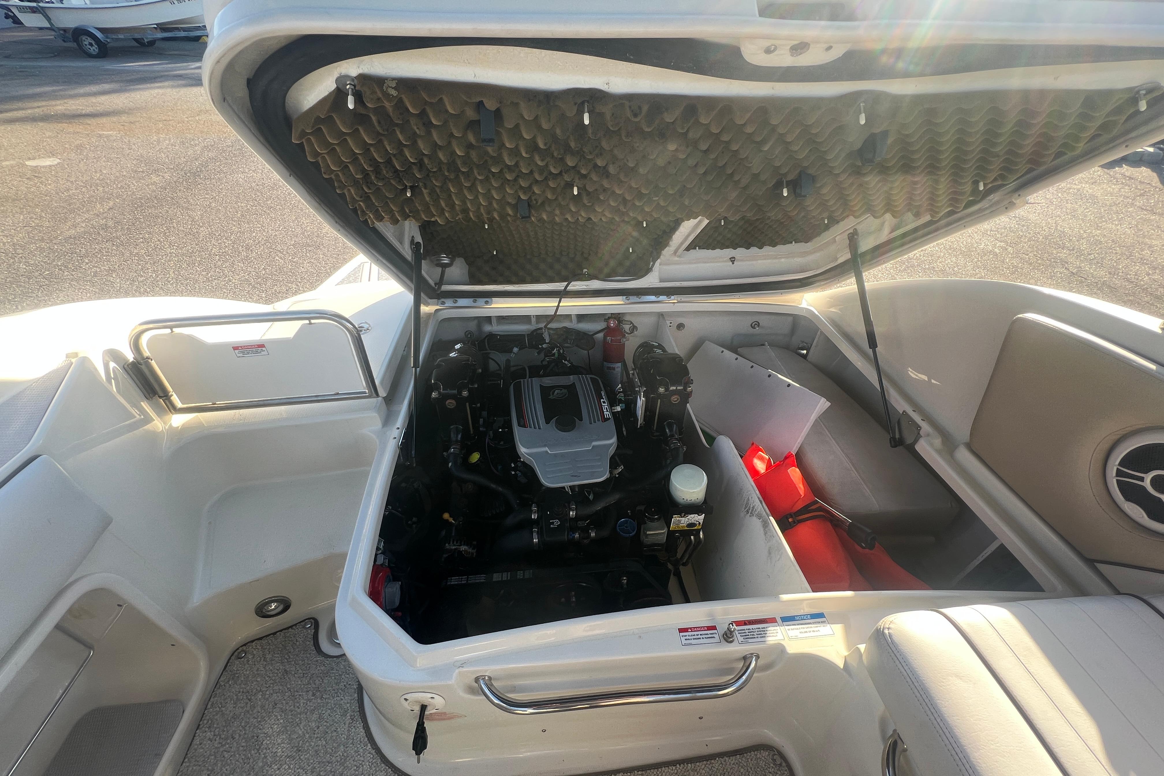 Engine compartment of a 2009 Sea Ray 210 Sundeck boat, showcasing interior details.
