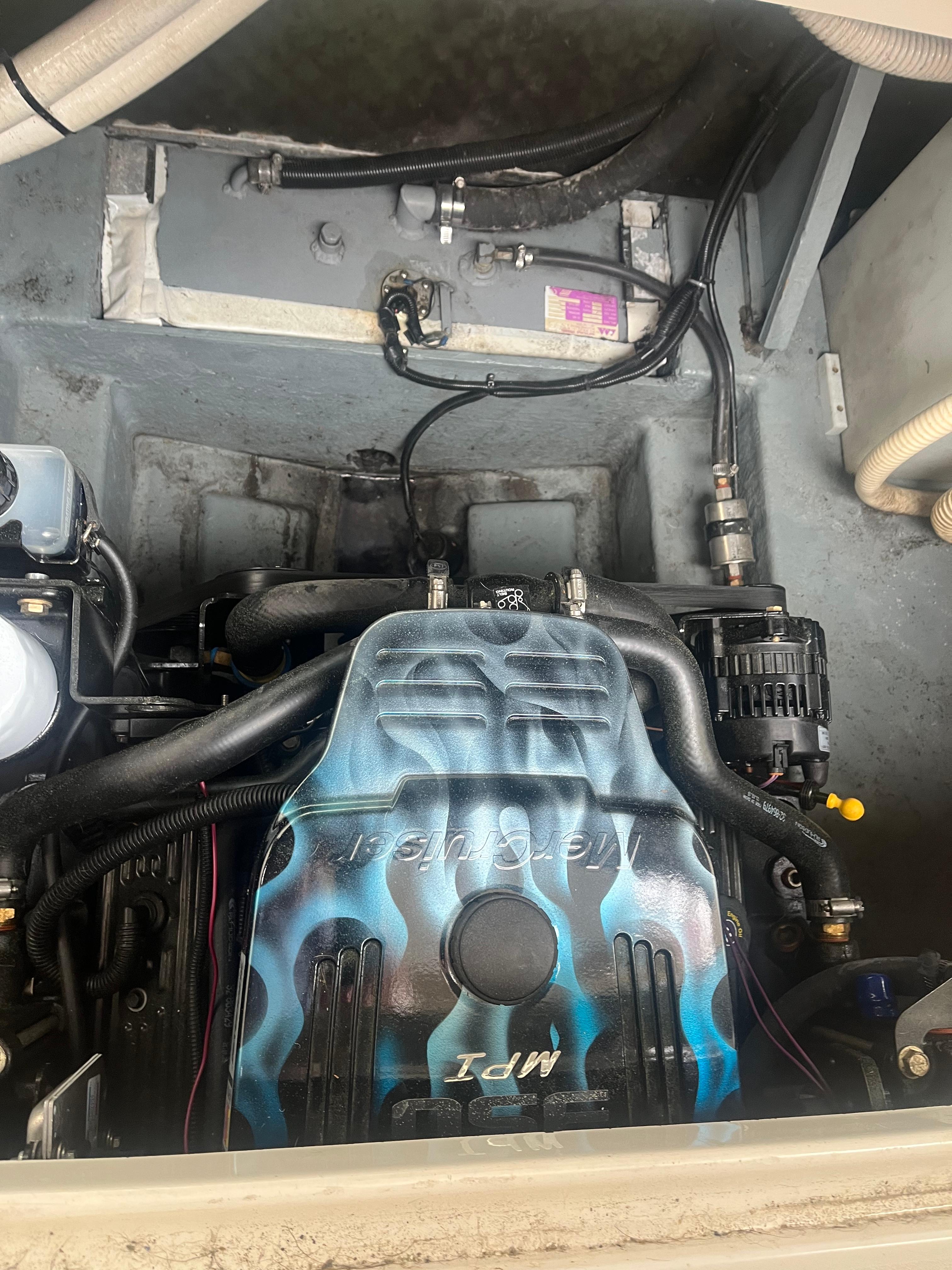 1995 Sea Ray 250 Sundancer engine compartment with custom-painted engine cover.