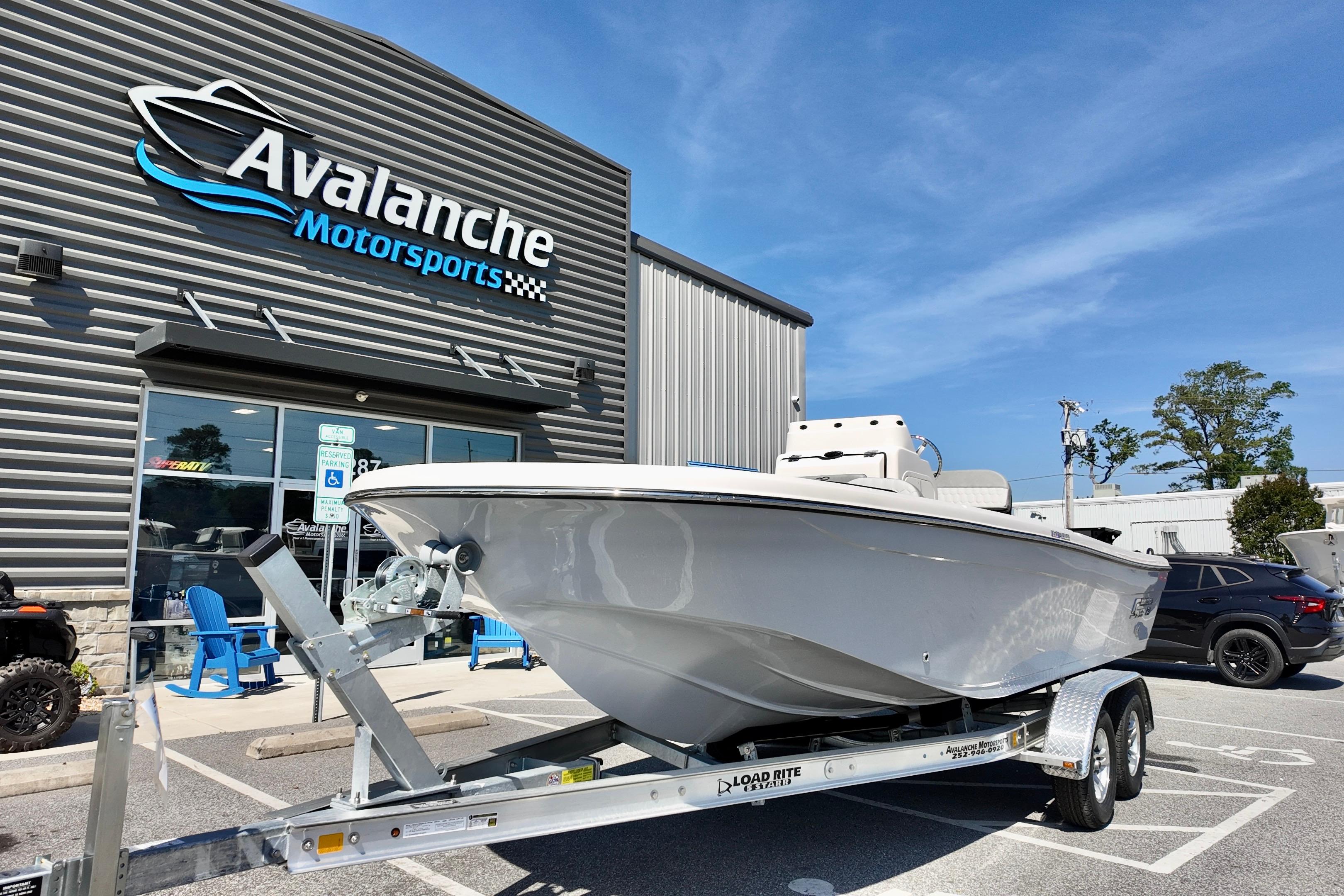 2026 Carolina Skiff 21 Ultra Elite boat on trailer at Avalanche Motorsports dealership.