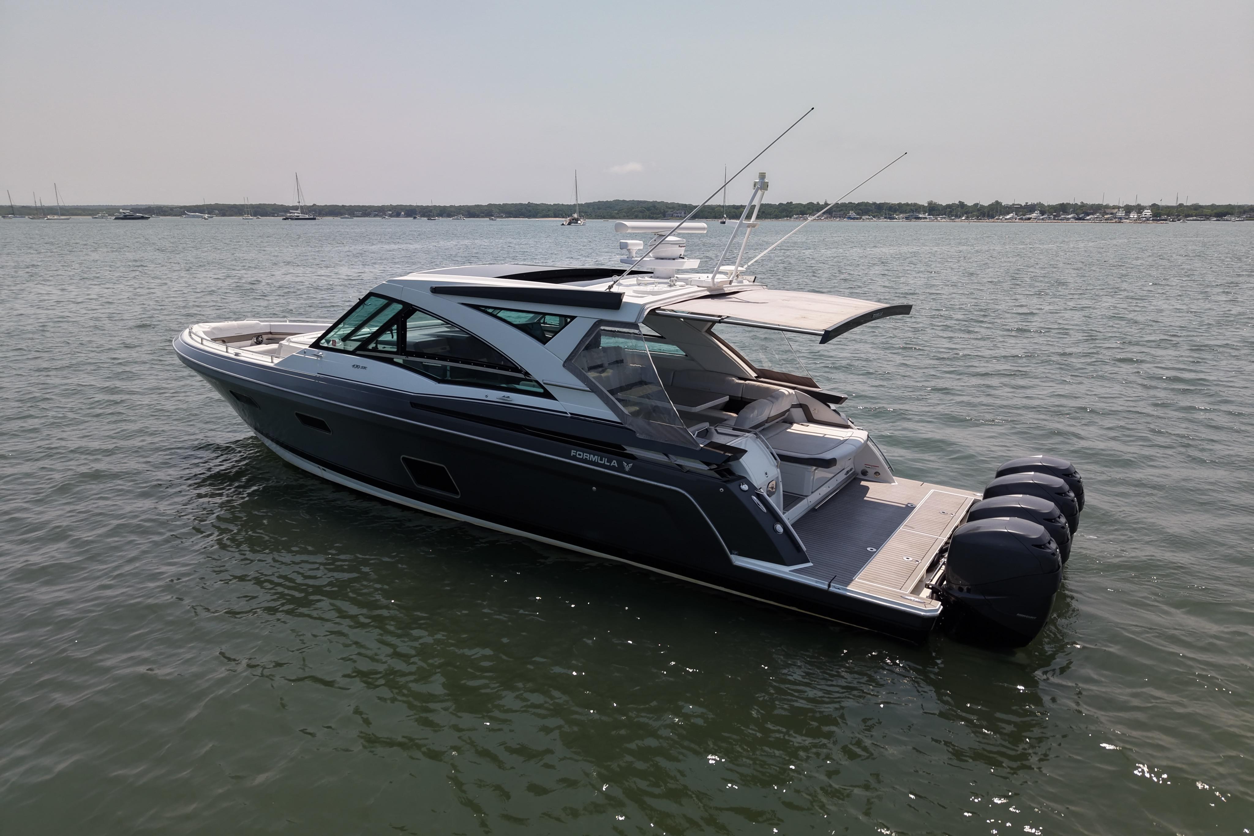 2019 Formula 430 Super Sport Crossover boat on calm water, featuring sleek design and powerful engines.
