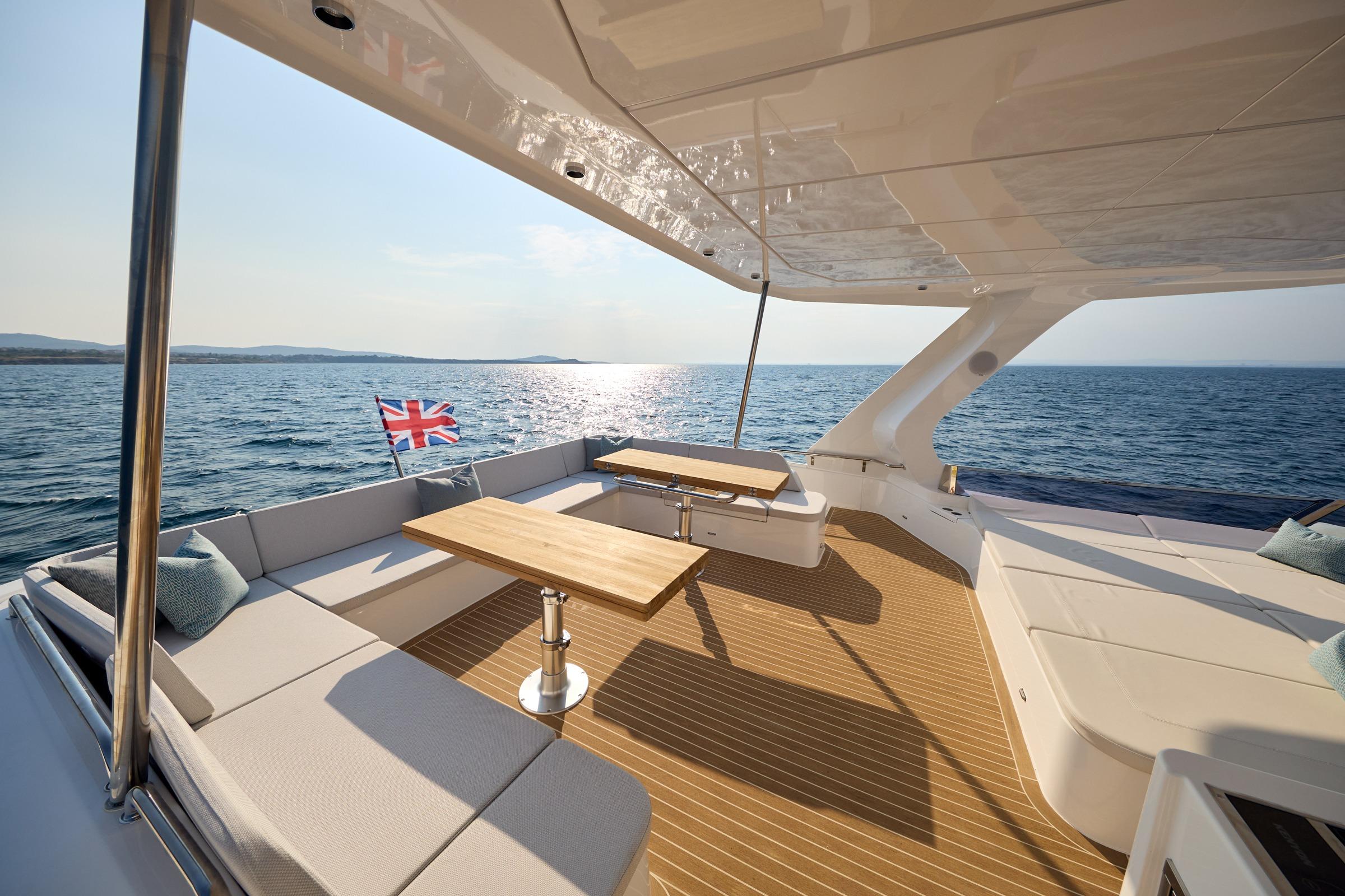 Luxurious 2025 Omaya 50 Power Catamaran deck with seating, tables, and ocean view.